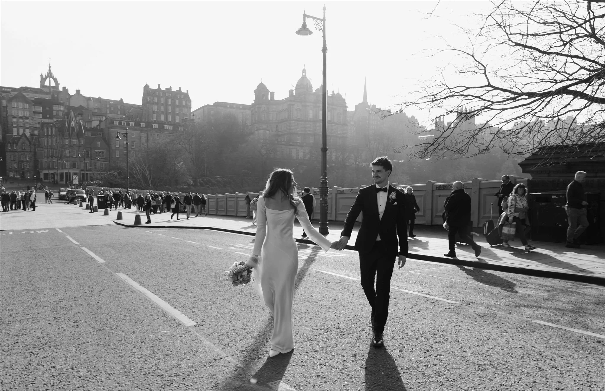 Bride and groom strolling around outside Edinburgh City Chambers, captured by an Edinburgh City Chambers wedding photographer in a cinematic style.