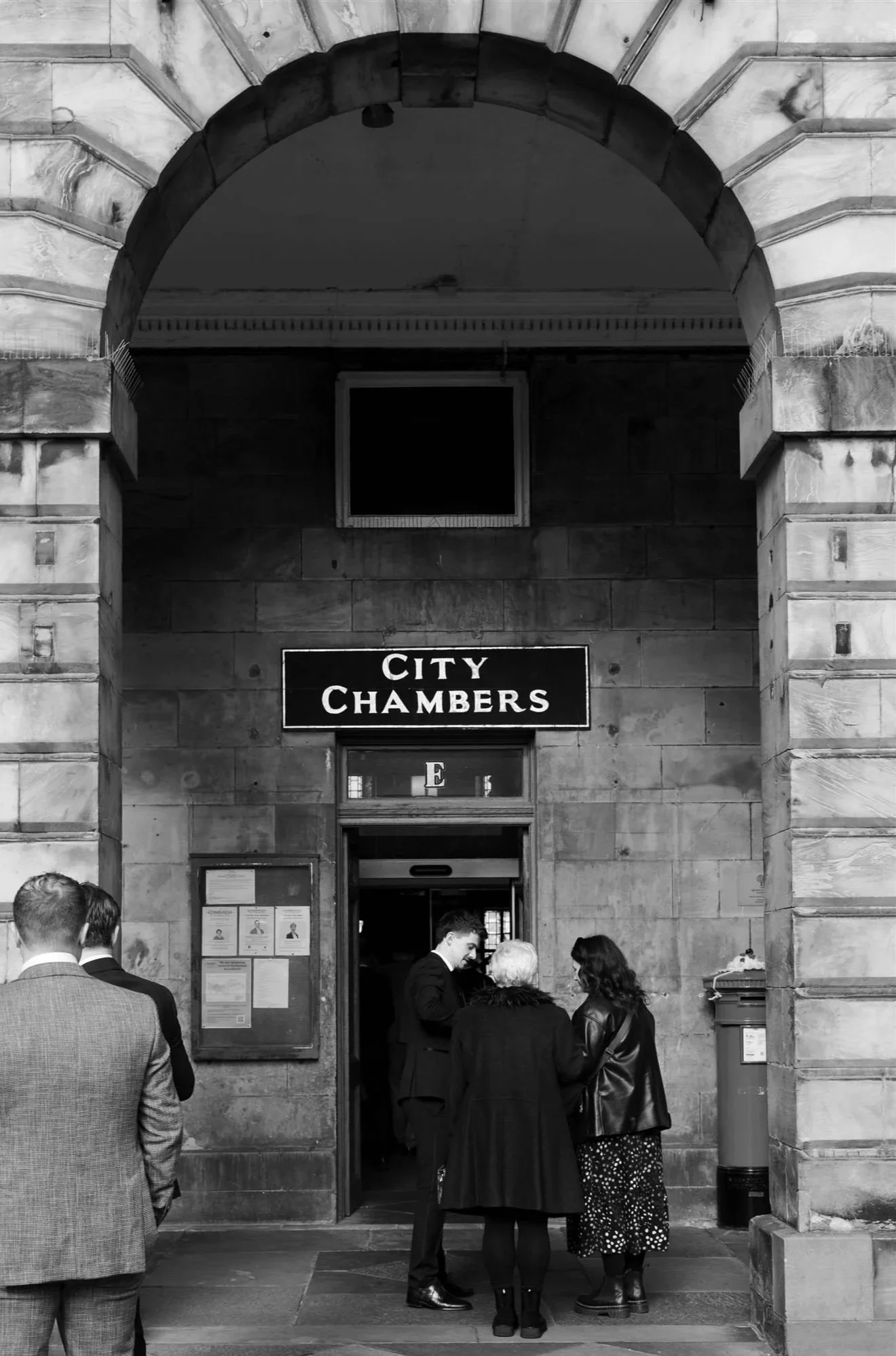 Wedding guests outside Edinburgh City Chambers on their wedding day in Edinburgh.