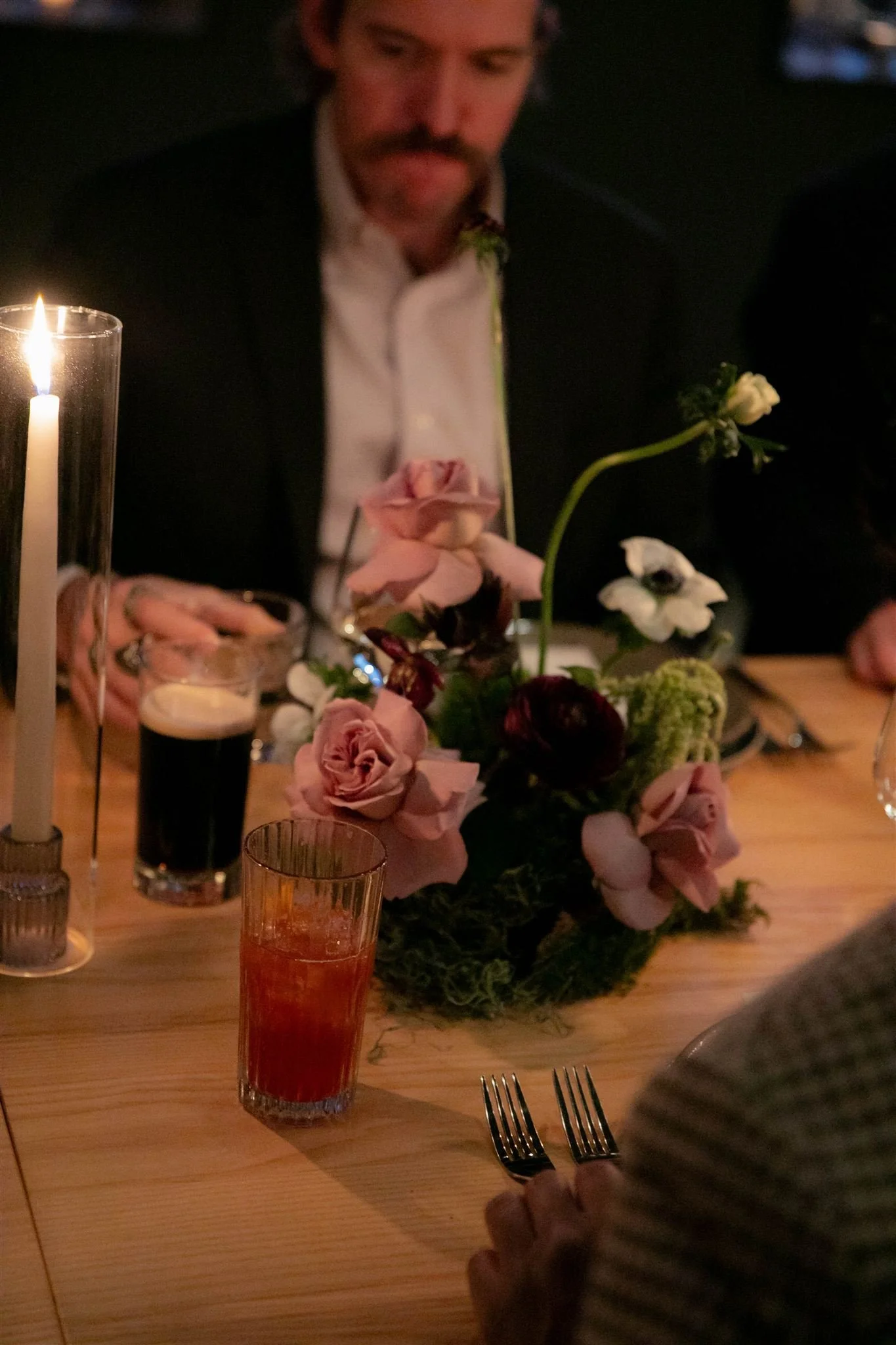 Wedding guests at a candlelit rehearsal dinner at Maxwells Trading Chicago wedding venue.
