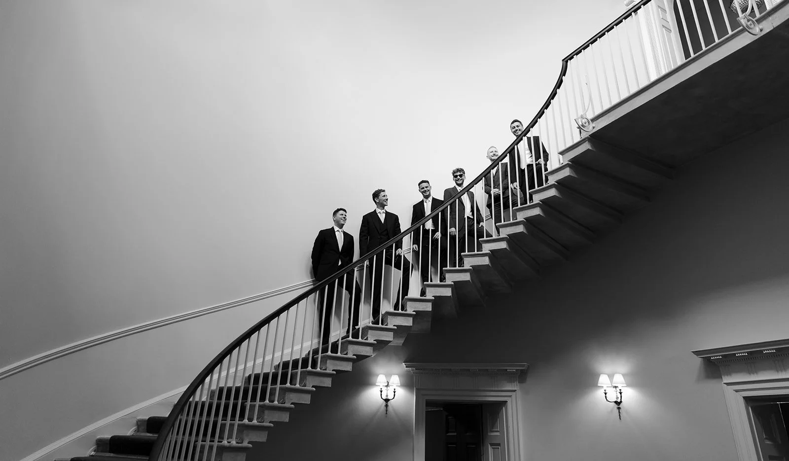 Groomsmen on the staircase in Middleton Lodge Estate on a wedding day in North Yorkshire.