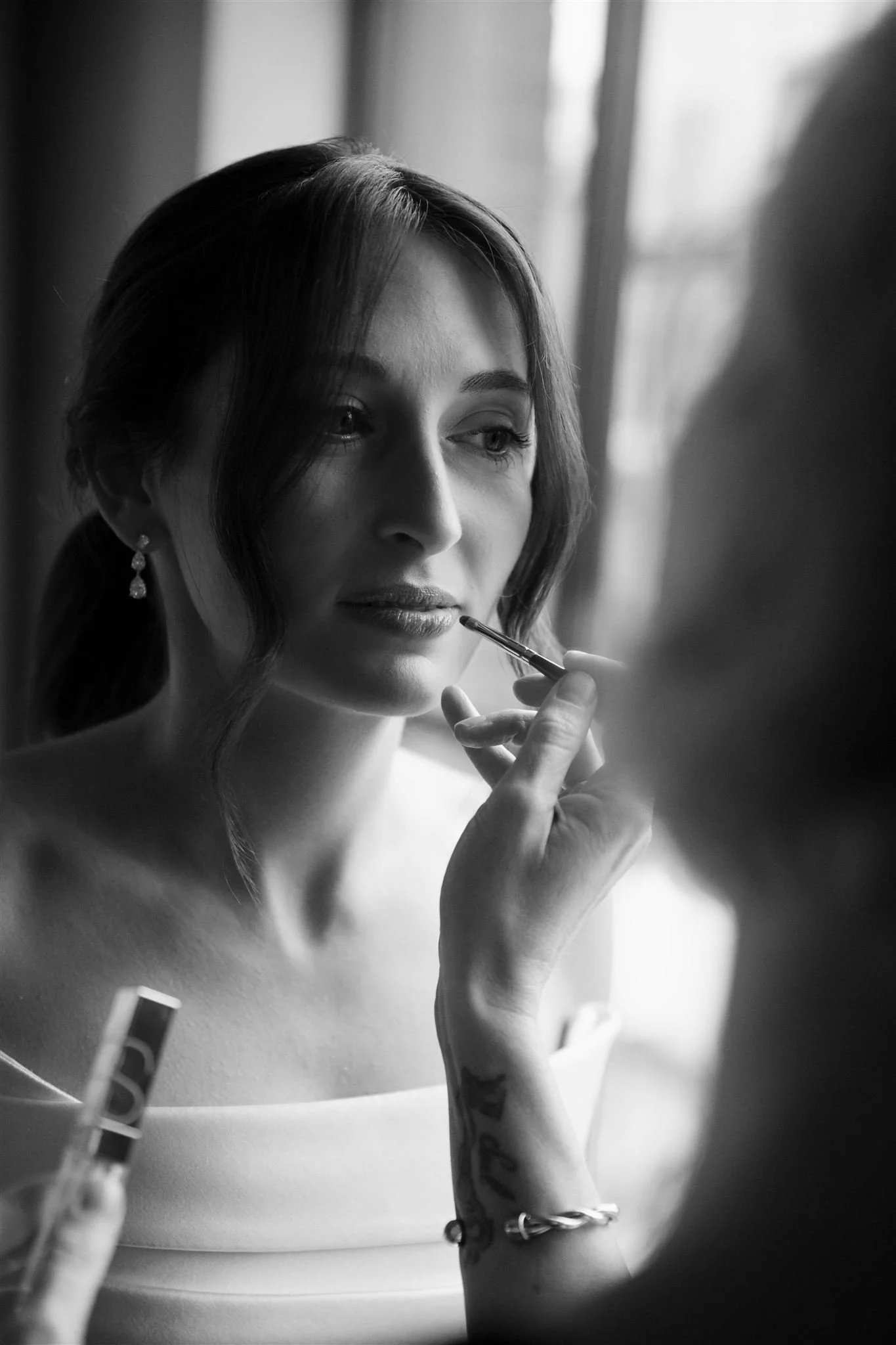 Bride getting ready in Nobu Hotel suite overlooking downtown Chicago skyline on her wedding day.