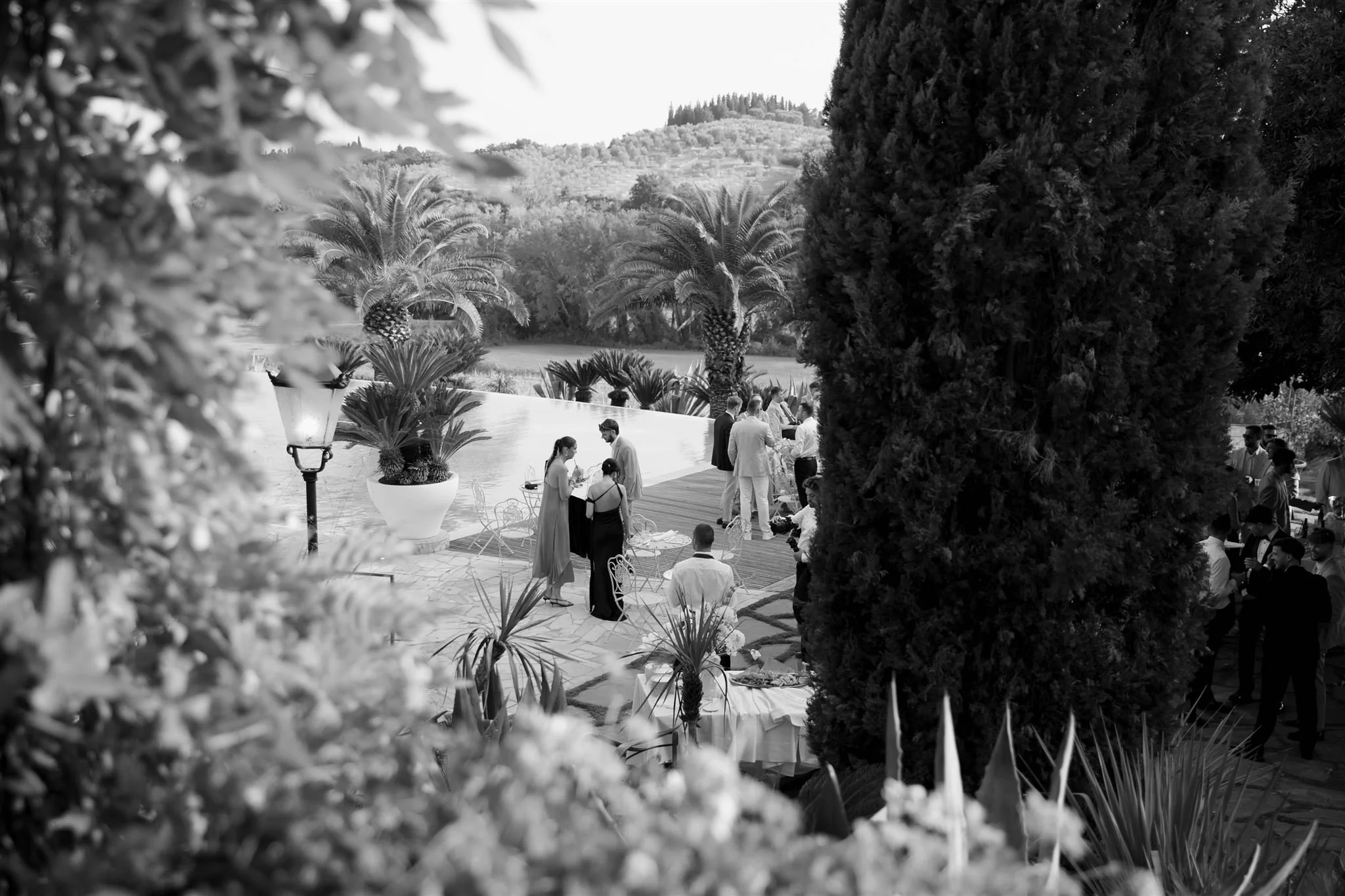 A poolside cocktail hour on a wedding day at Tenuta Corbinaia Villa in Tuscany, Italy.
