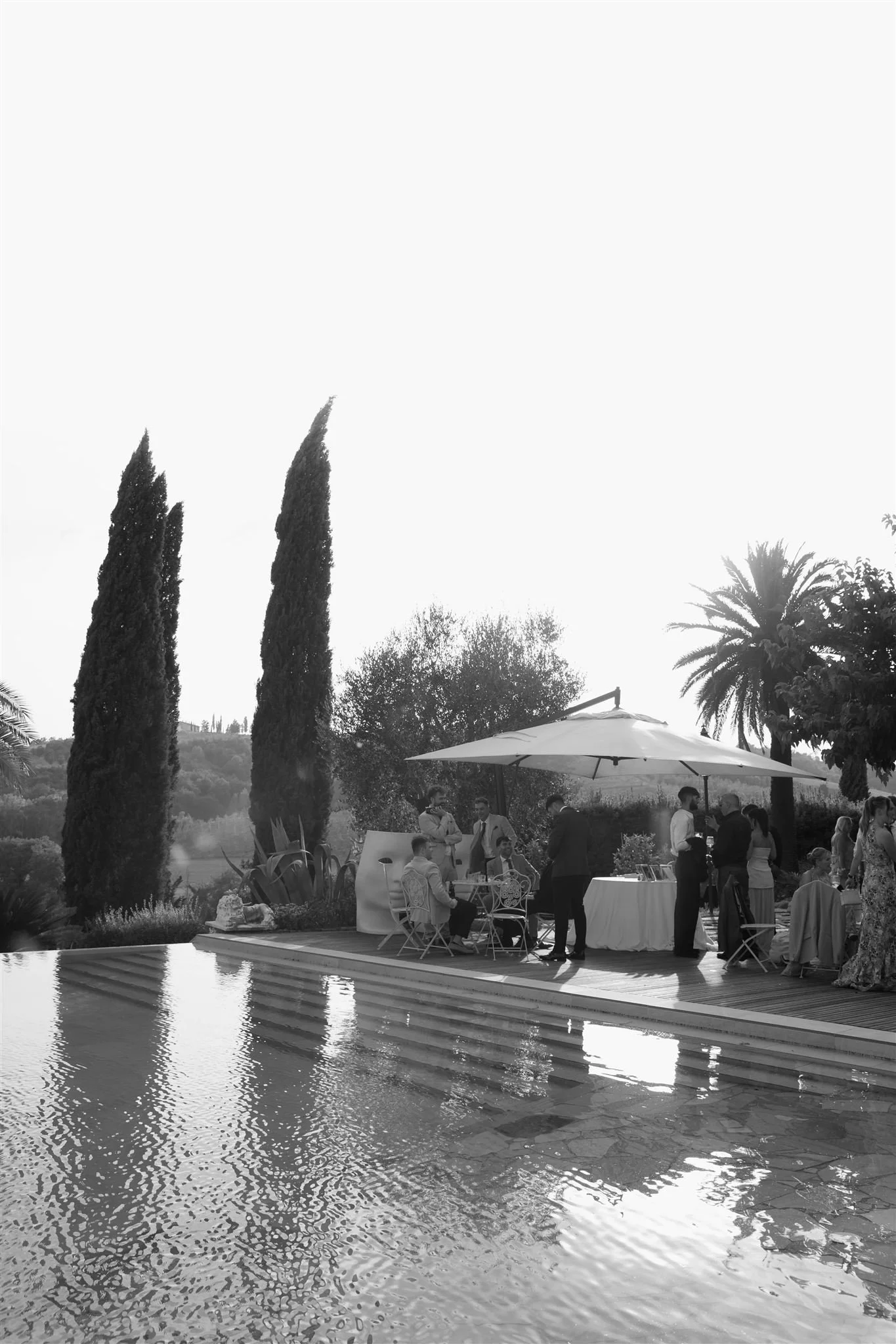 A poolside cocktail hour on a wedding day at Tenuta Corbinaia Villa in Tuscany, Italy.