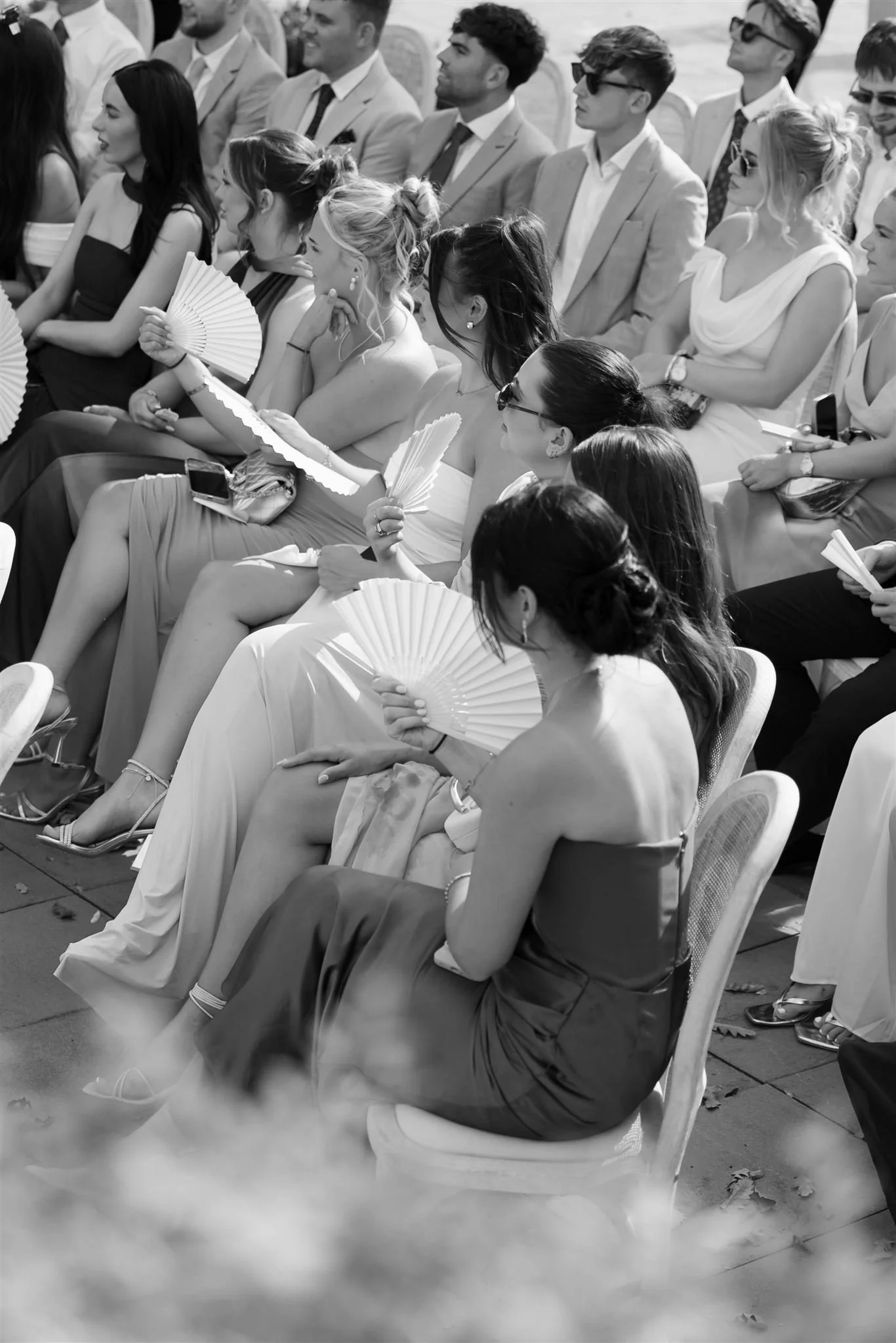Wedding guest fans on a wedding day at Tenuta Corbinaia Villa in Tuscany, Italy.