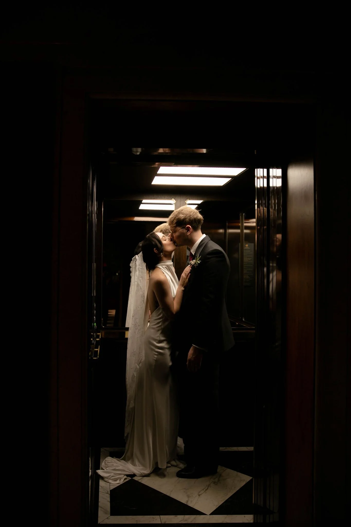 Couple photo in an elevator on a wedding day at the Edinburgh Grand Hotel in Edinburgh, Scotland.