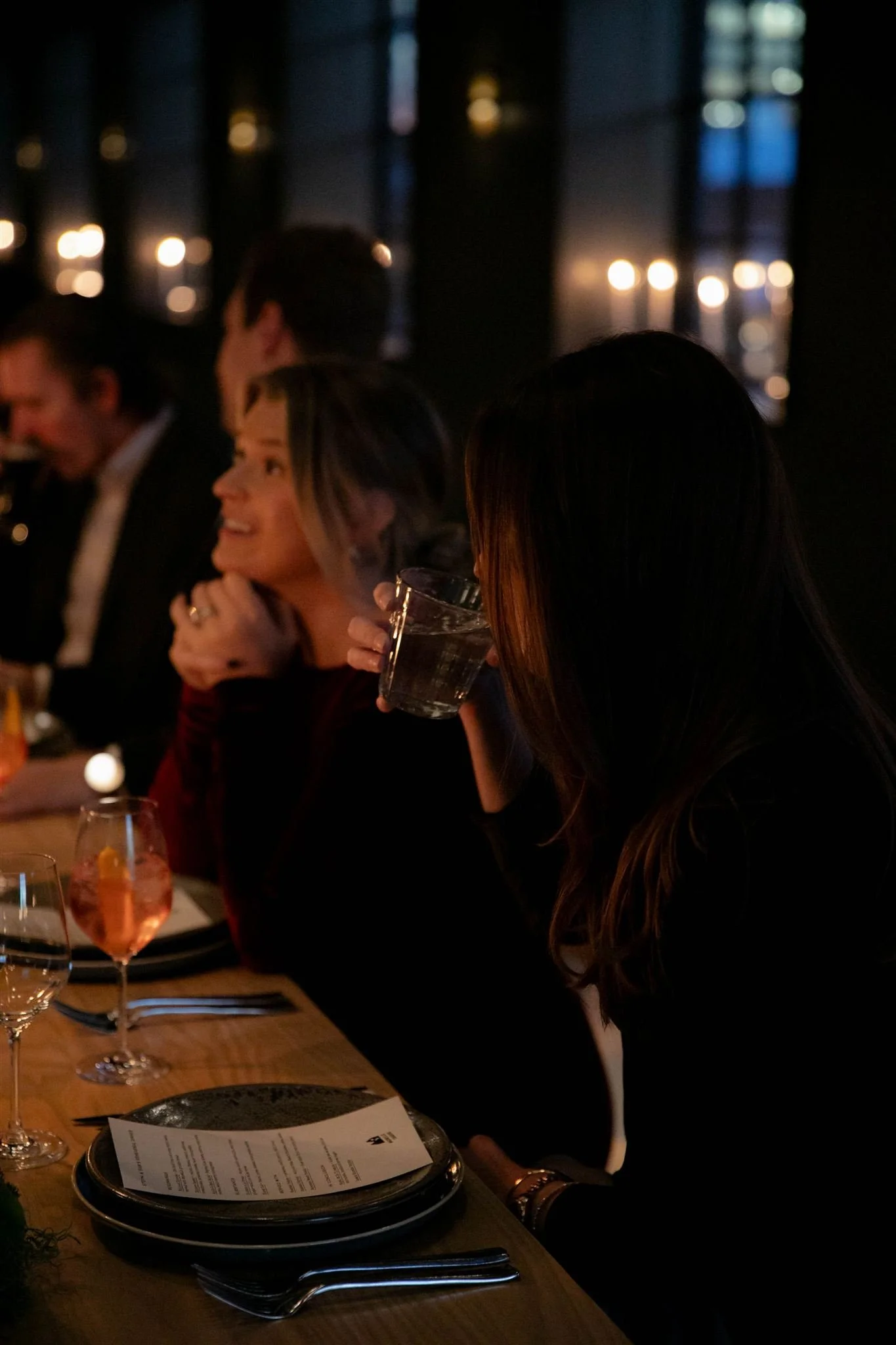 Wedding guests at a candlelit rehearsal dinner at Maxwells Trading Chicago wedding venue.
