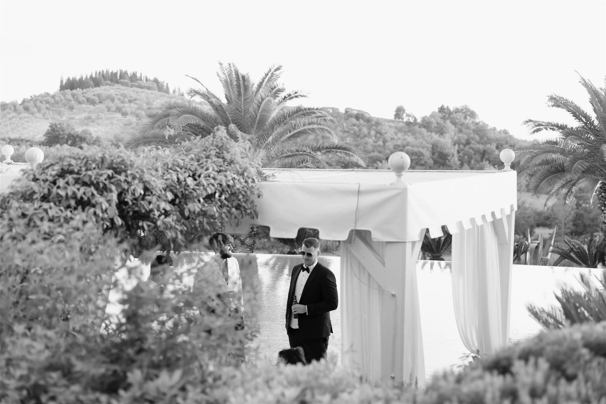 A poolside cocktail hour on a wedding day at Tenuta Corbinaia Villa in Tuscany, Italy.