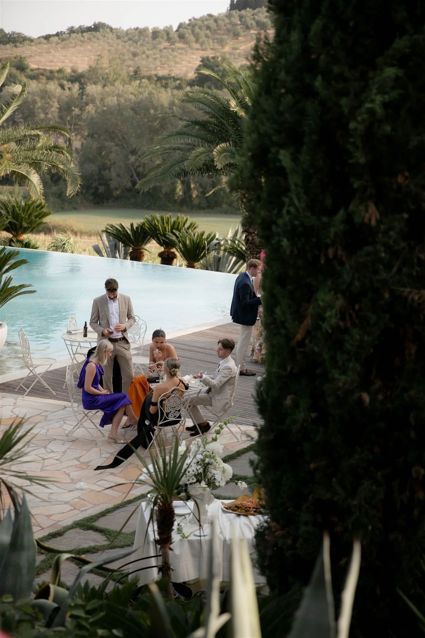 A poolside cocktail hour on a wedding day at Tenuta Corbinaia Villa in Tuscany, Italy.