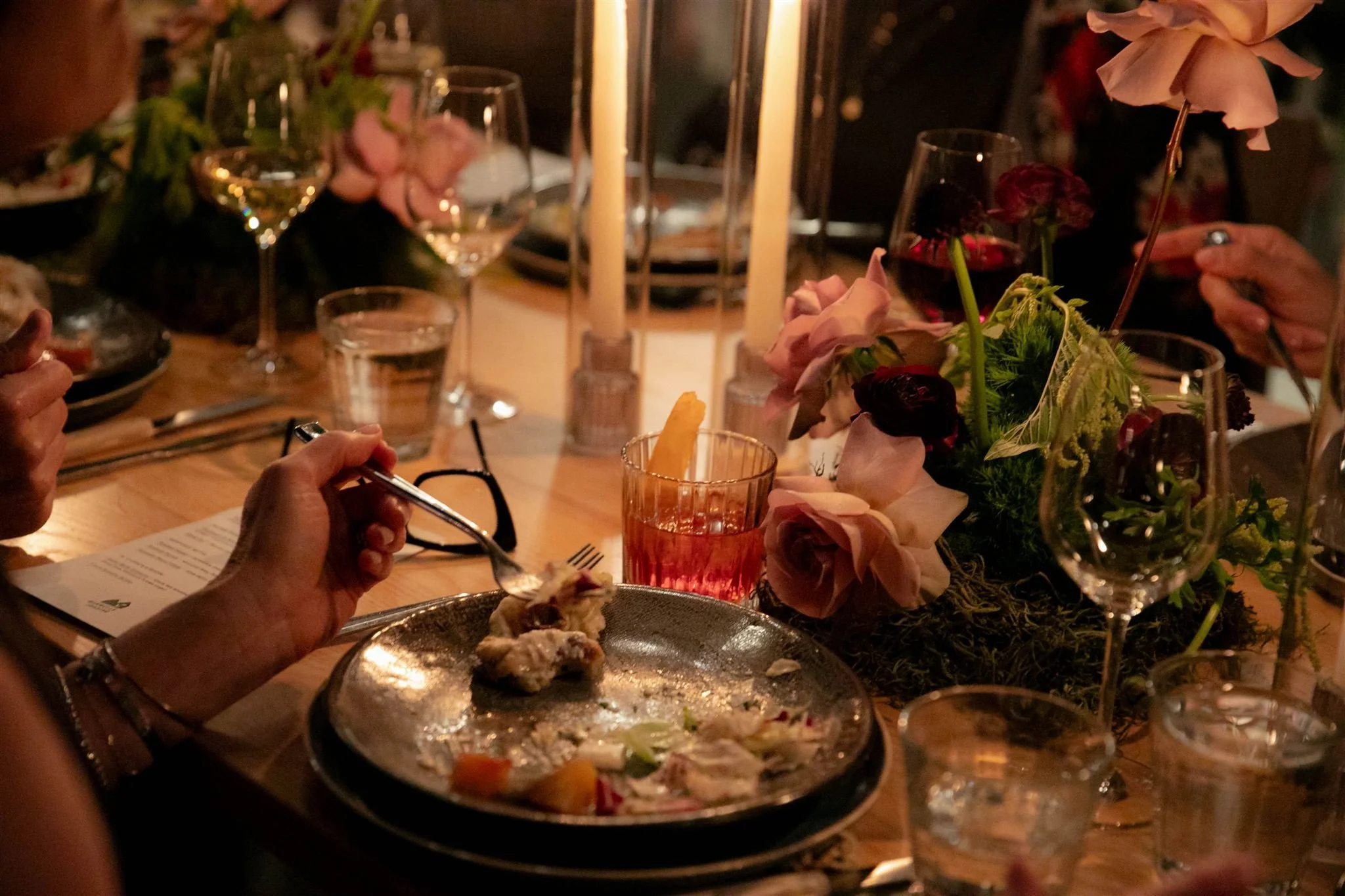 Wedding guests at a candlelit rehearsal dinner at Maxwells Trading Chicago wedding venue.