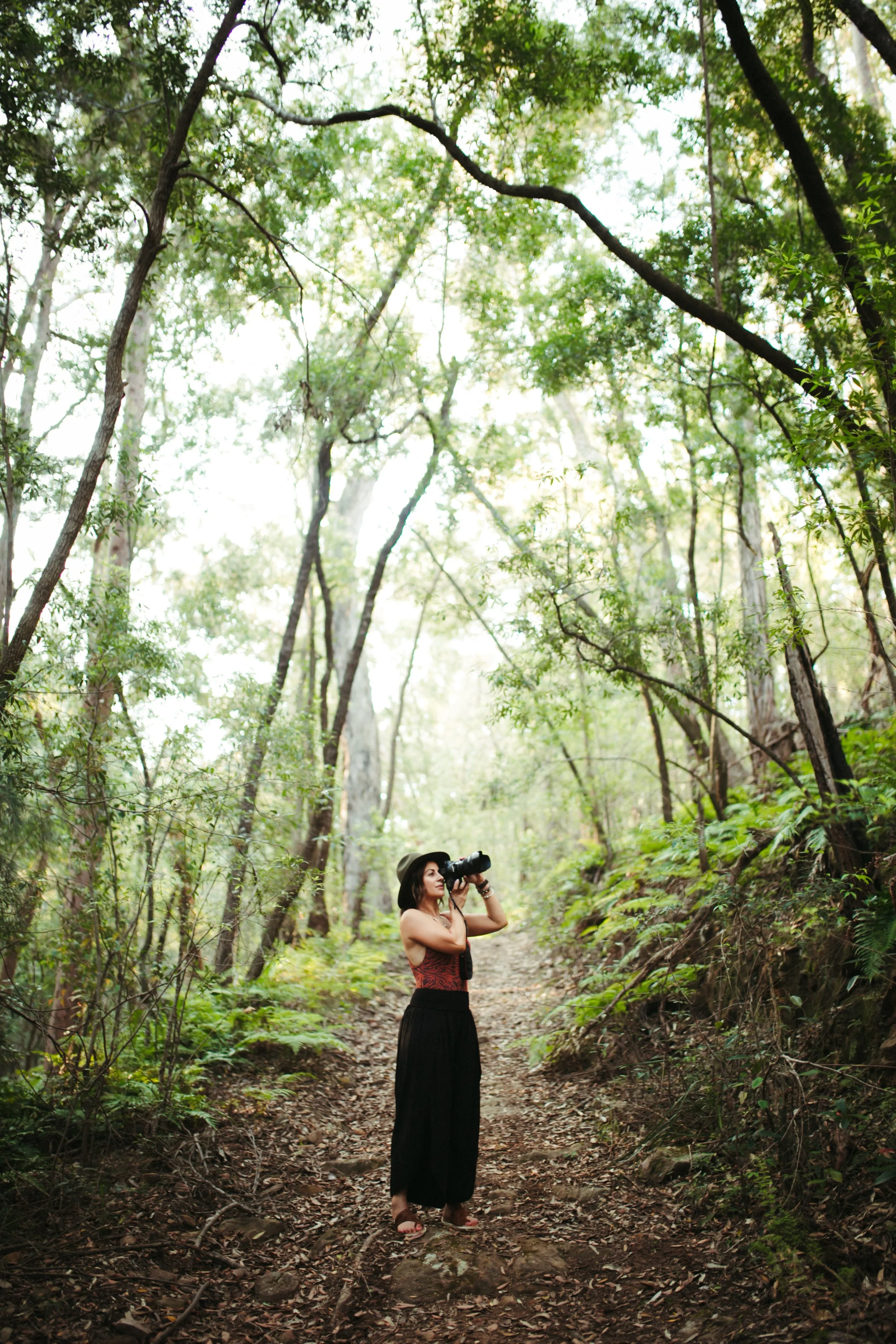 Jennifer Borg photographing in lush rainforest surroundings in NSW, Australia.