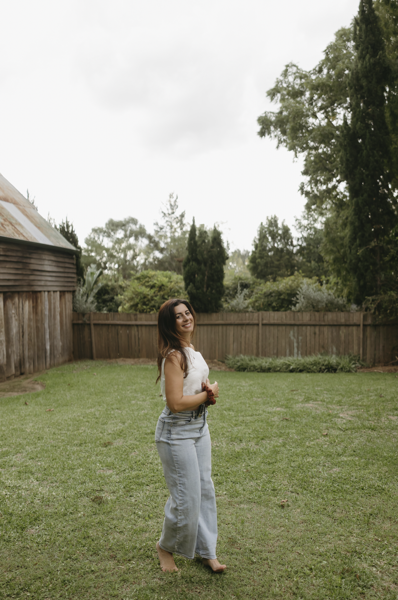 Woman in the garden smiling in movement.