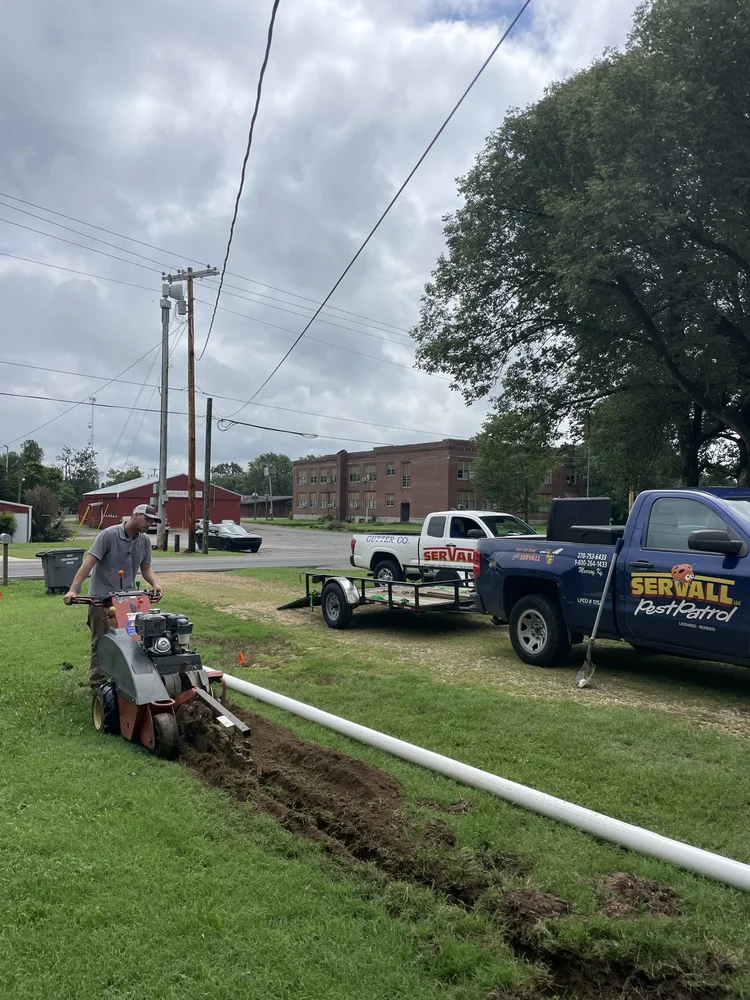 Servall crew installing underground pipe system