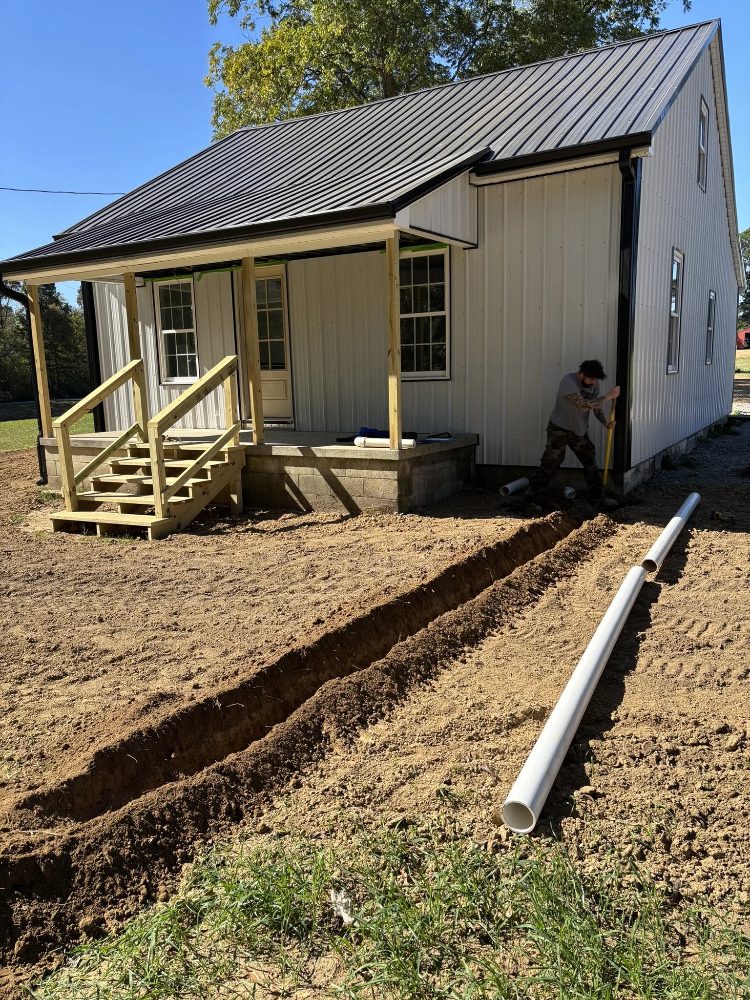 Servall crew on underground downspout drain installation