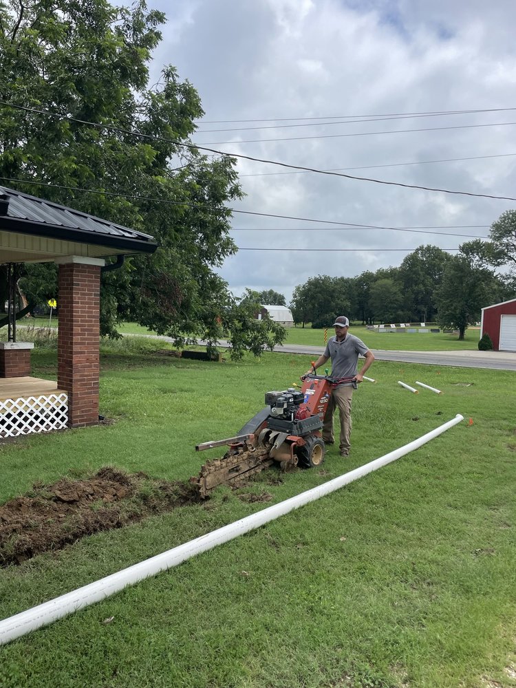 Trenching machine for underground downspout drain