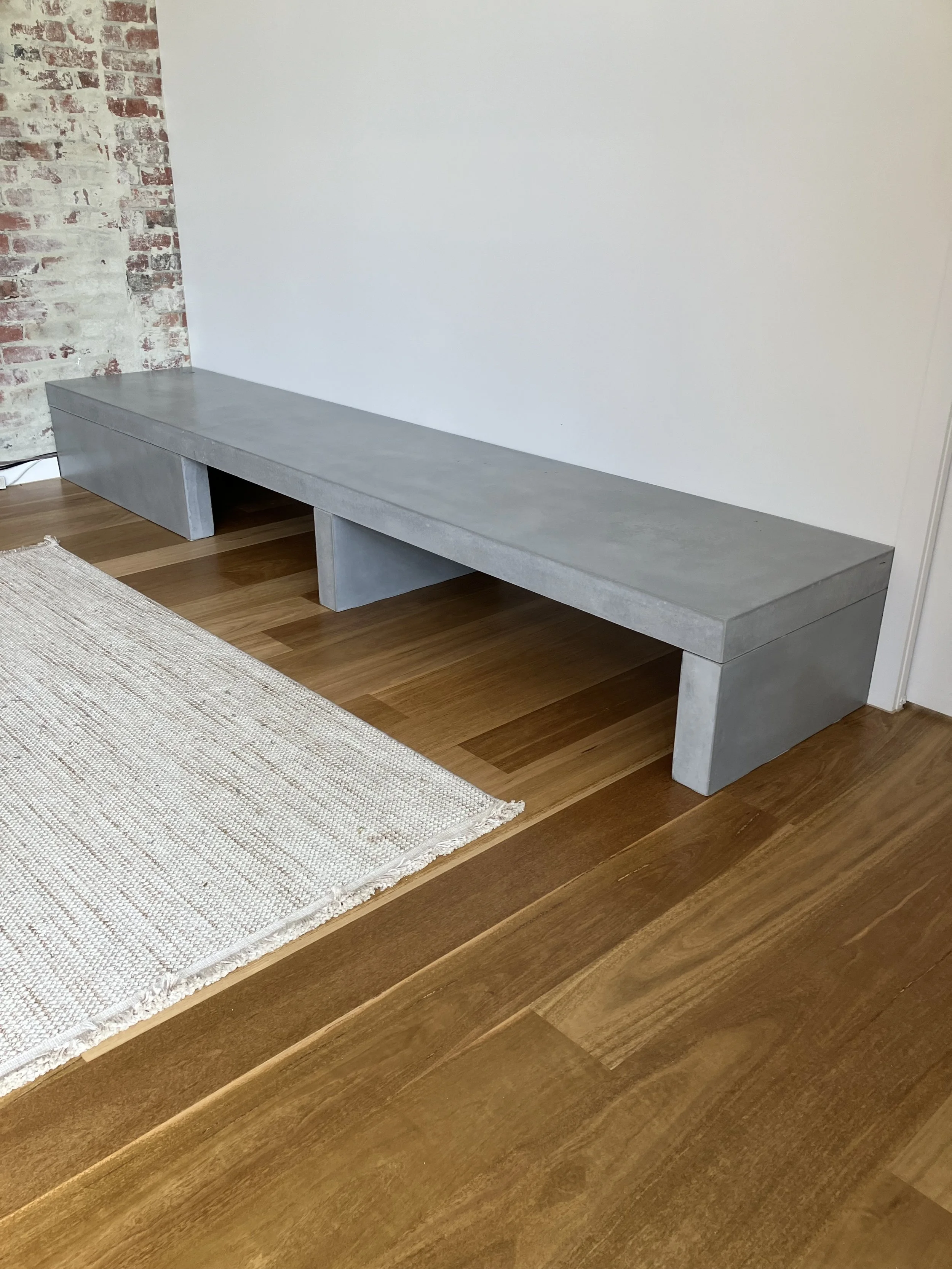 Concrete hearth with timber flooring contrast, showcasing a clean and durable finish in Melbourne.