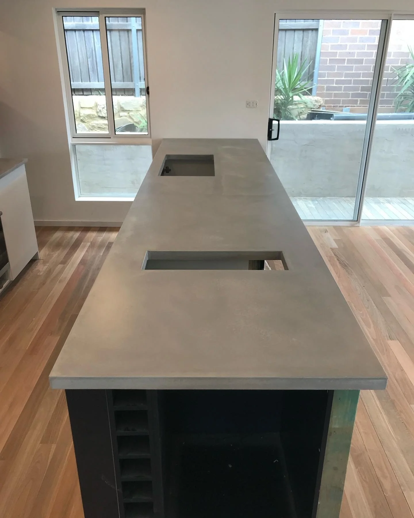 Long polished concrete benchtop with seamless finish and integrated sink cutout Melbourne

