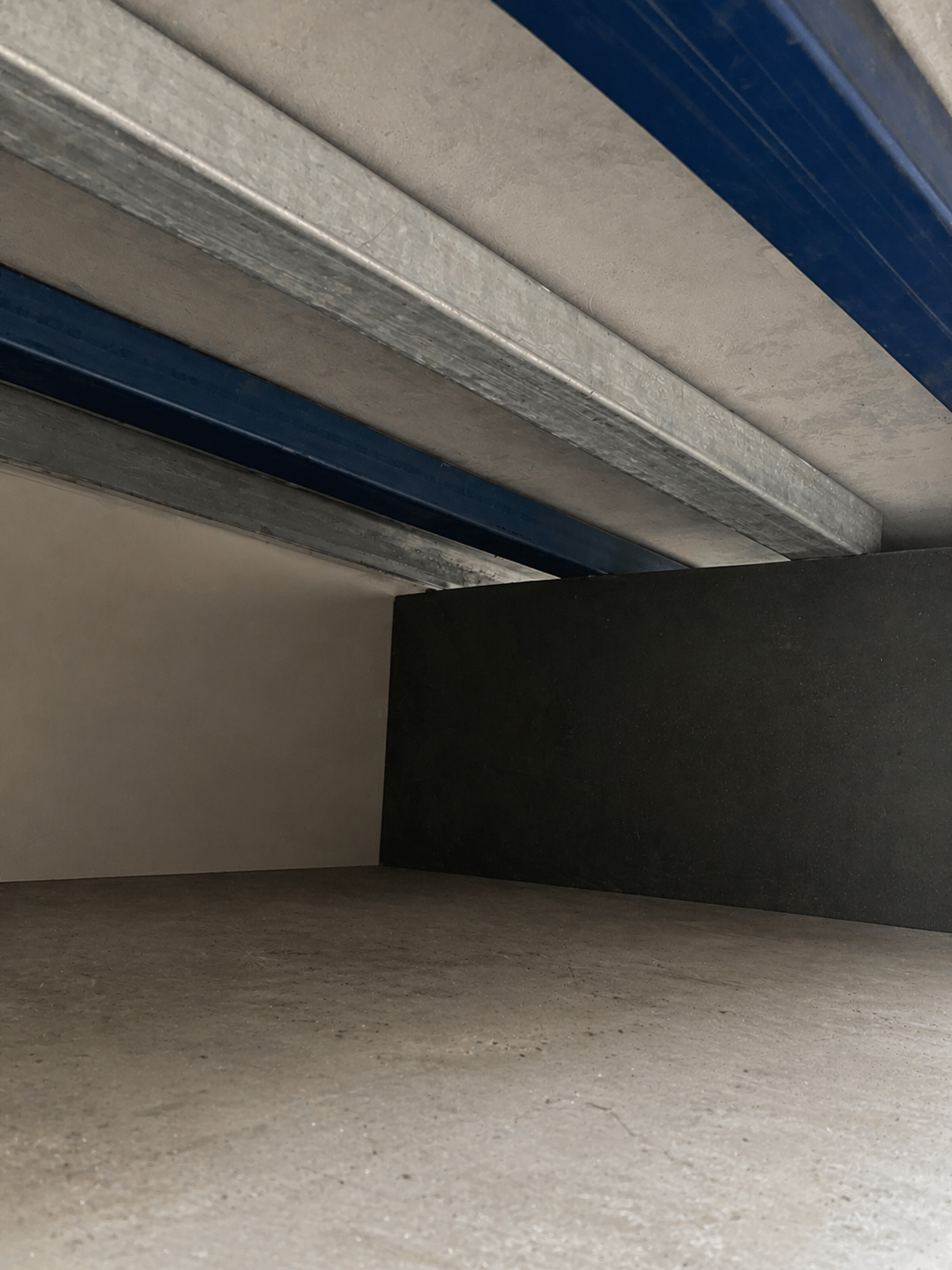 Hidden steel span support structure for concrete fireplace hearth installed in Melbourne