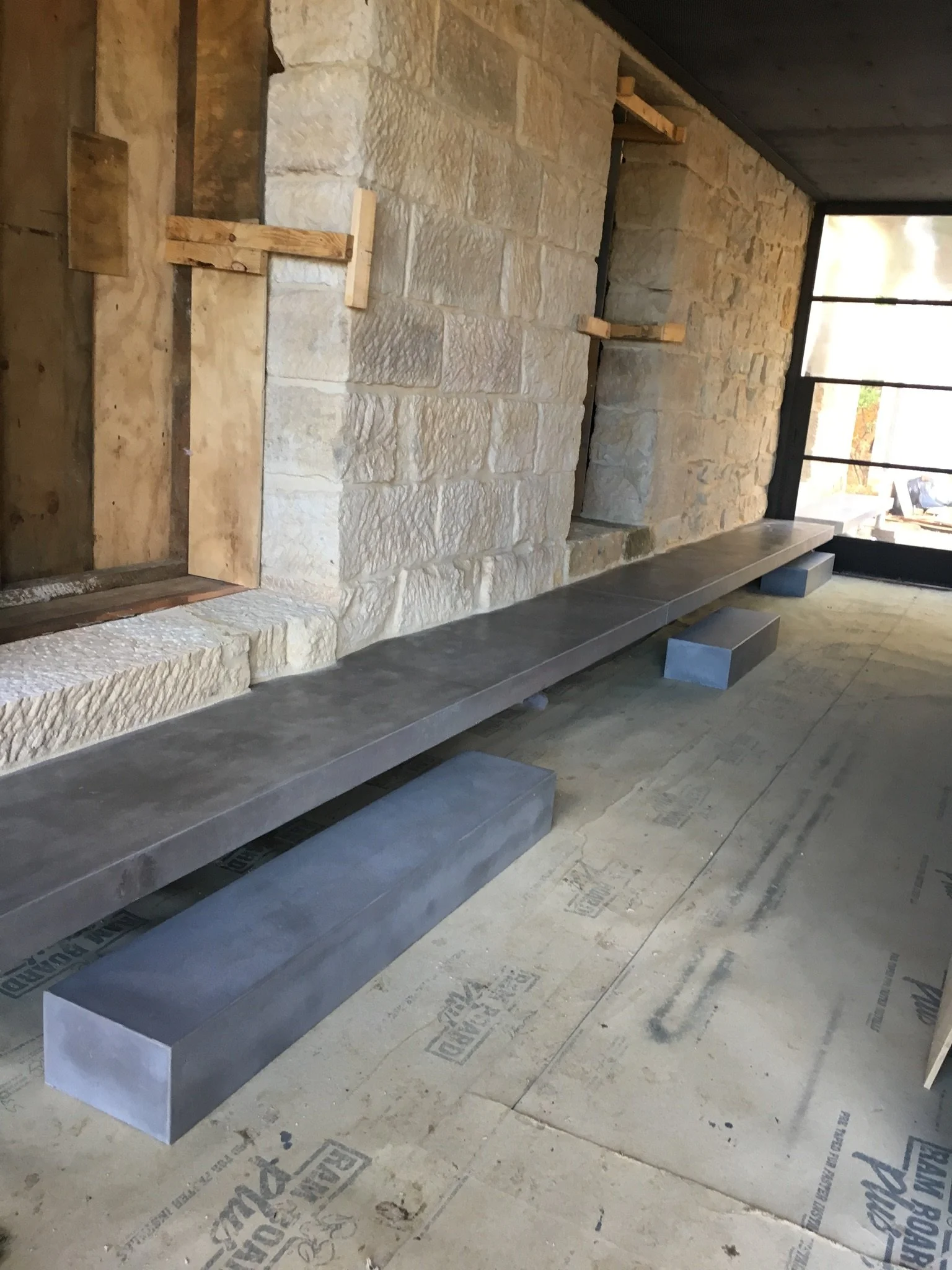 Floating Concrete hearth in Melbourne with concealed steel bracket system, creating a seamless architectural finish.