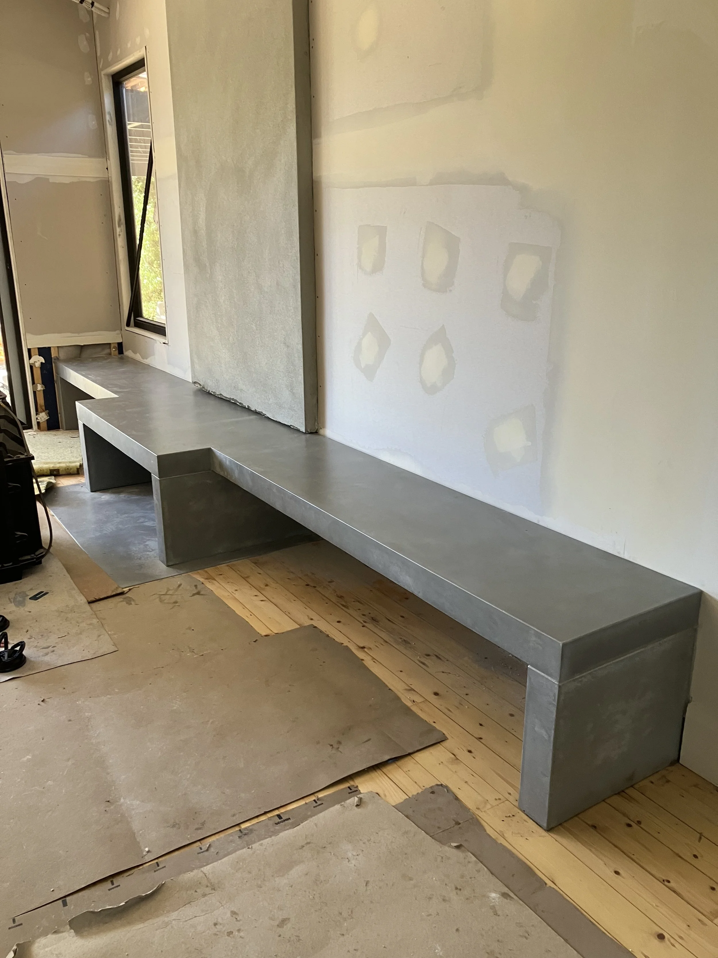 Long linear concrete hearth design in Melbourne with extended span and architectural finish.