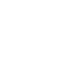 Scenic landscape of a mountain range with a lake in the foreground and grassy hills, under a cloudy sky.