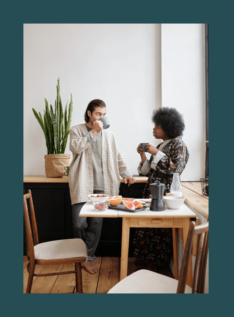 two people talking while drinking coffee
