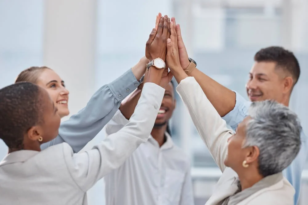 team of diverse people giving high five