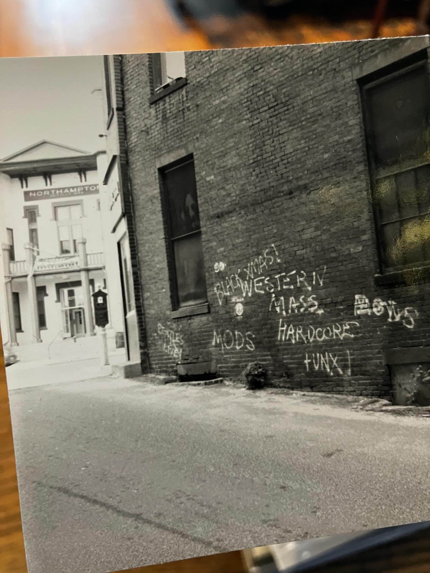 downtown noho in the early 80s when it was still hamp (iykyk) and gritty and full of graffiti and punk kids 📸 a big stack of snapshots of northampton, mass - all cars and buildings - no people 

#northamptonma #hampvsnoho #early80s #westernmasshardc