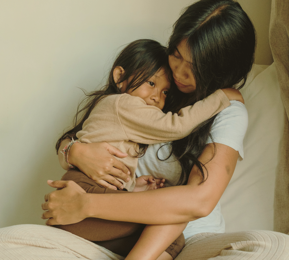 Mother holding her young child, representing somatic therapy for motherhood and identity for women in NYC.