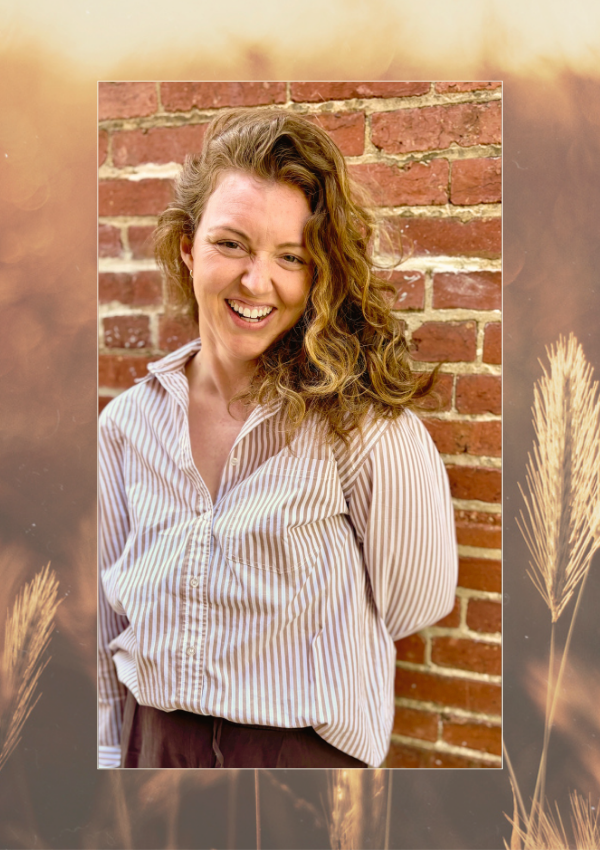 Kelsey Dunn, LMHC, somatic therapist in New York, standing against a brick wall.