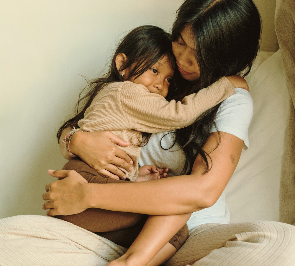 Mother holding her young child, representing somatic therapy for mothers and motherhood support in New York.