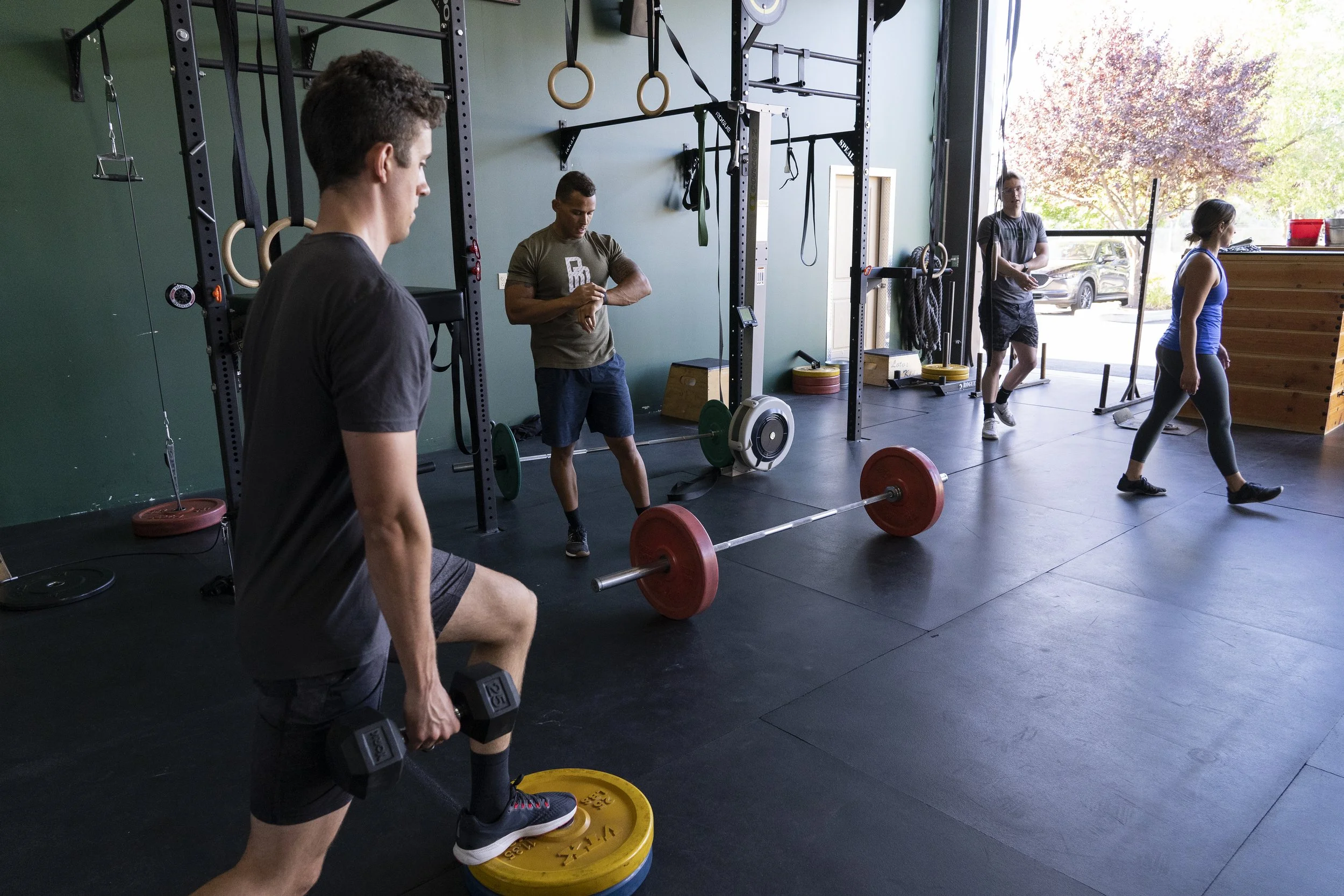 OPEX CDA members following individualized workouts while a coach provides guidance.