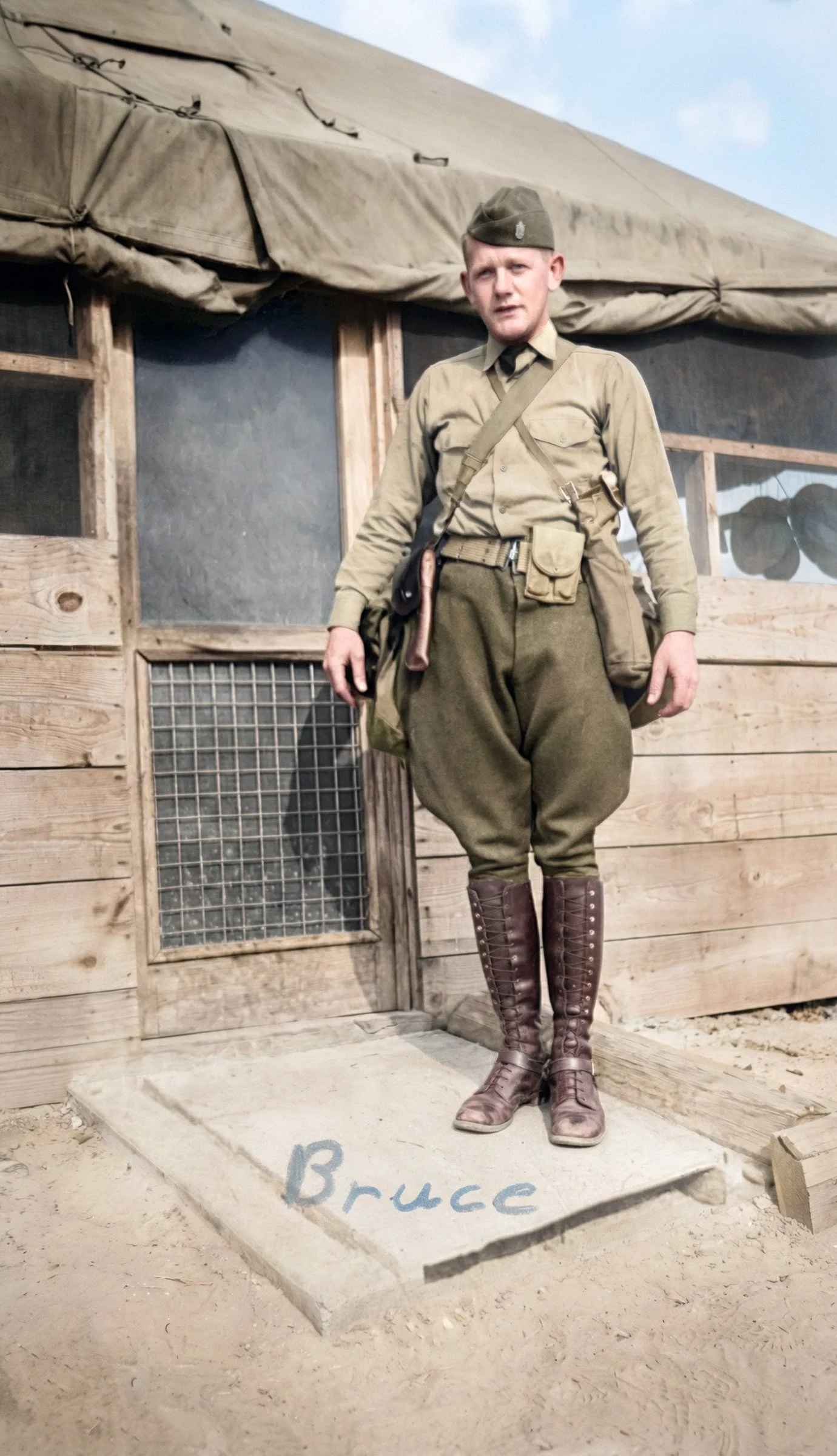 1941 photo of twenty-one-year-old Bruce Nostrand posing in front of a tent at Fort Jackson, South Carolina, as a member of the 102nd Cavalry. 