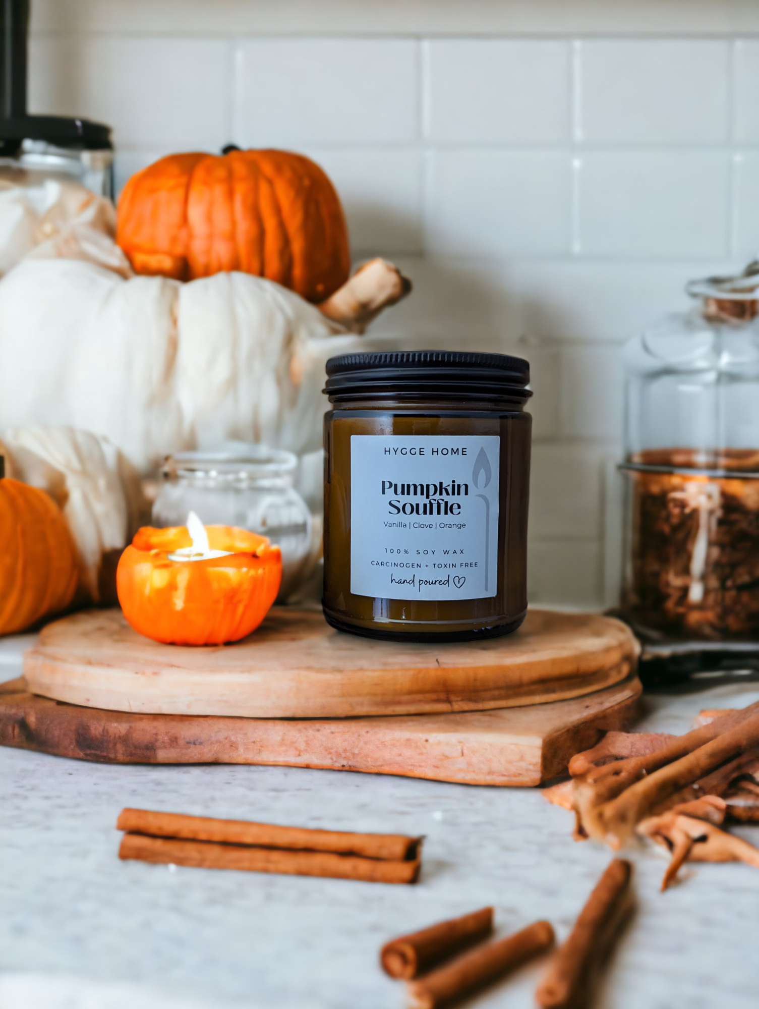 Pumpkin Scented Candle sitting on kitchen counter with fall decor