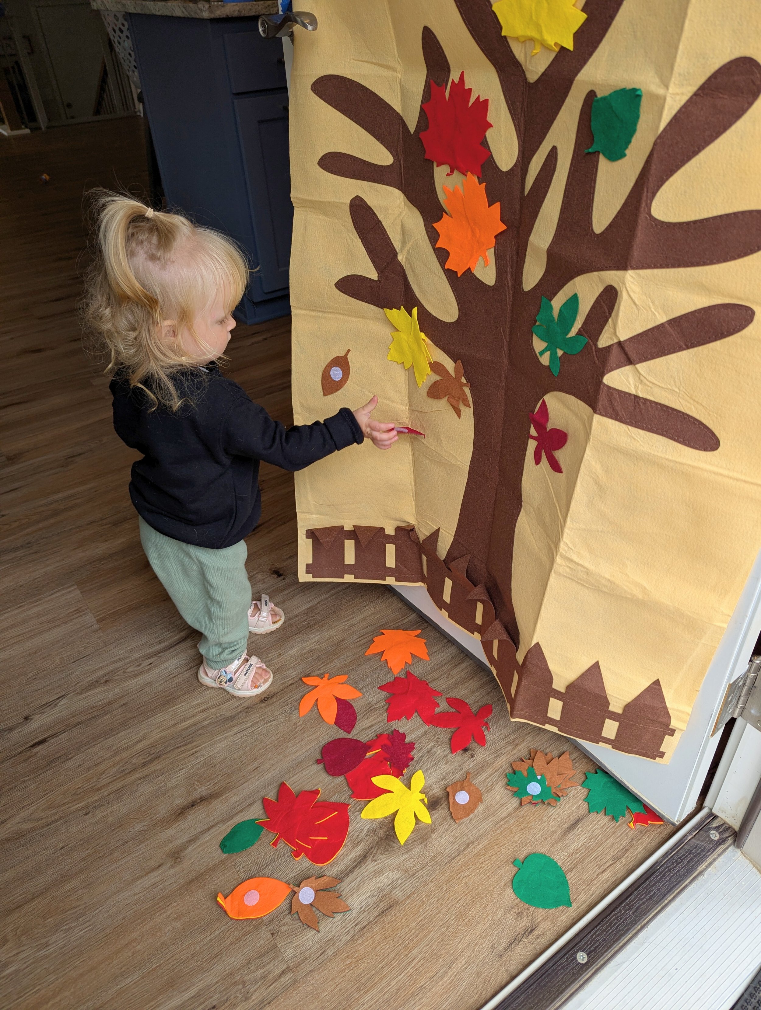 Toddler playing with fall felt leaf tree - velcro