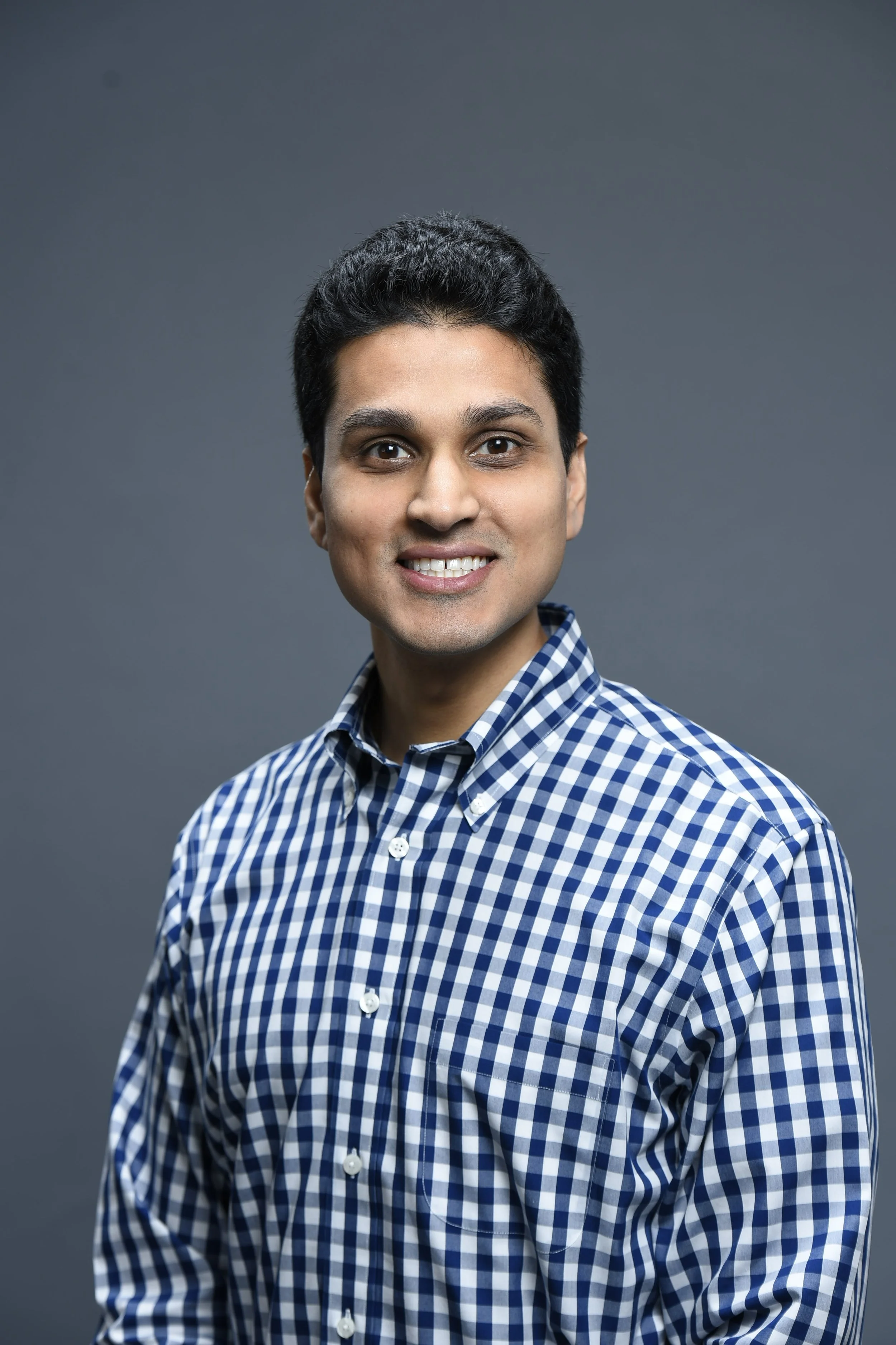Prashant Shukla in a button up smiling