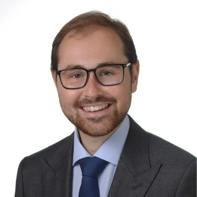 Daniel Linger headshit with him smiling in black eyeglasses