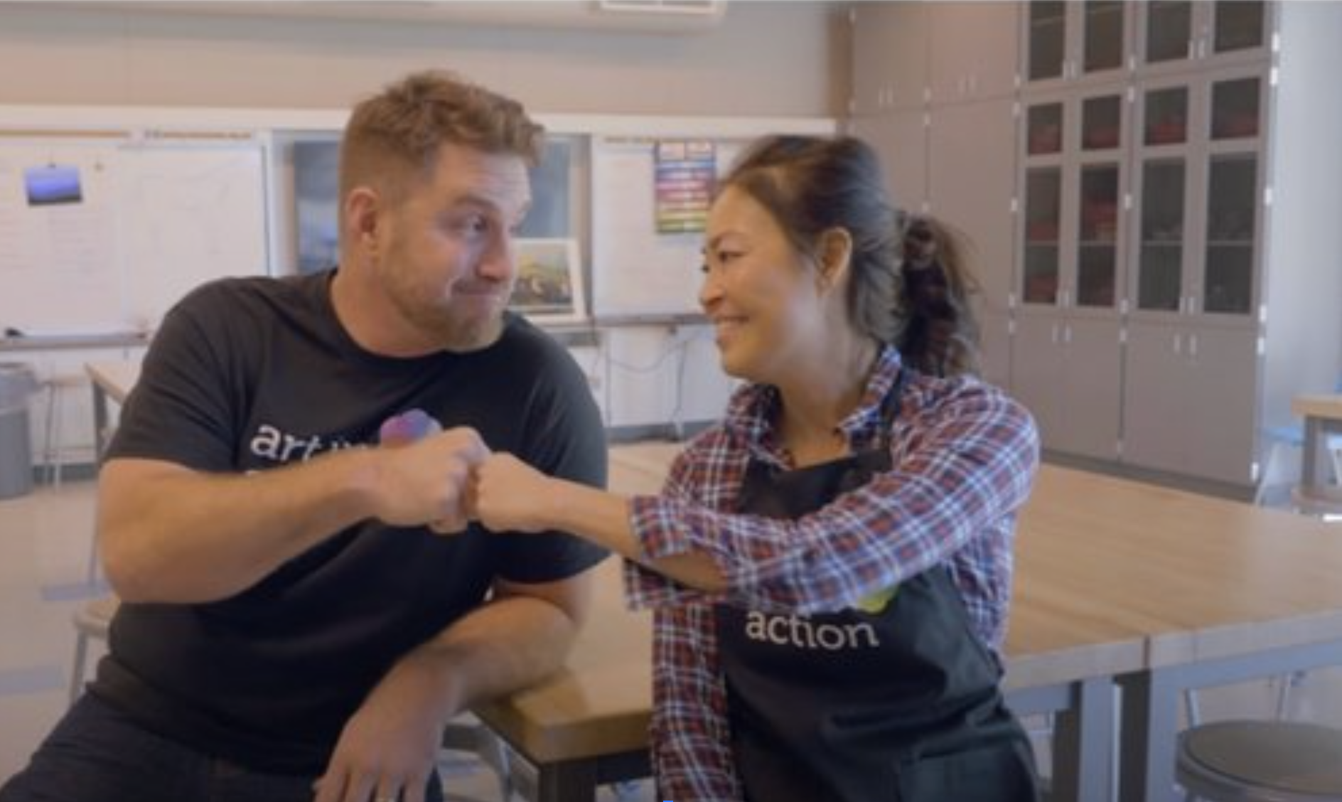 art instructor giving a fist bump to a school helper