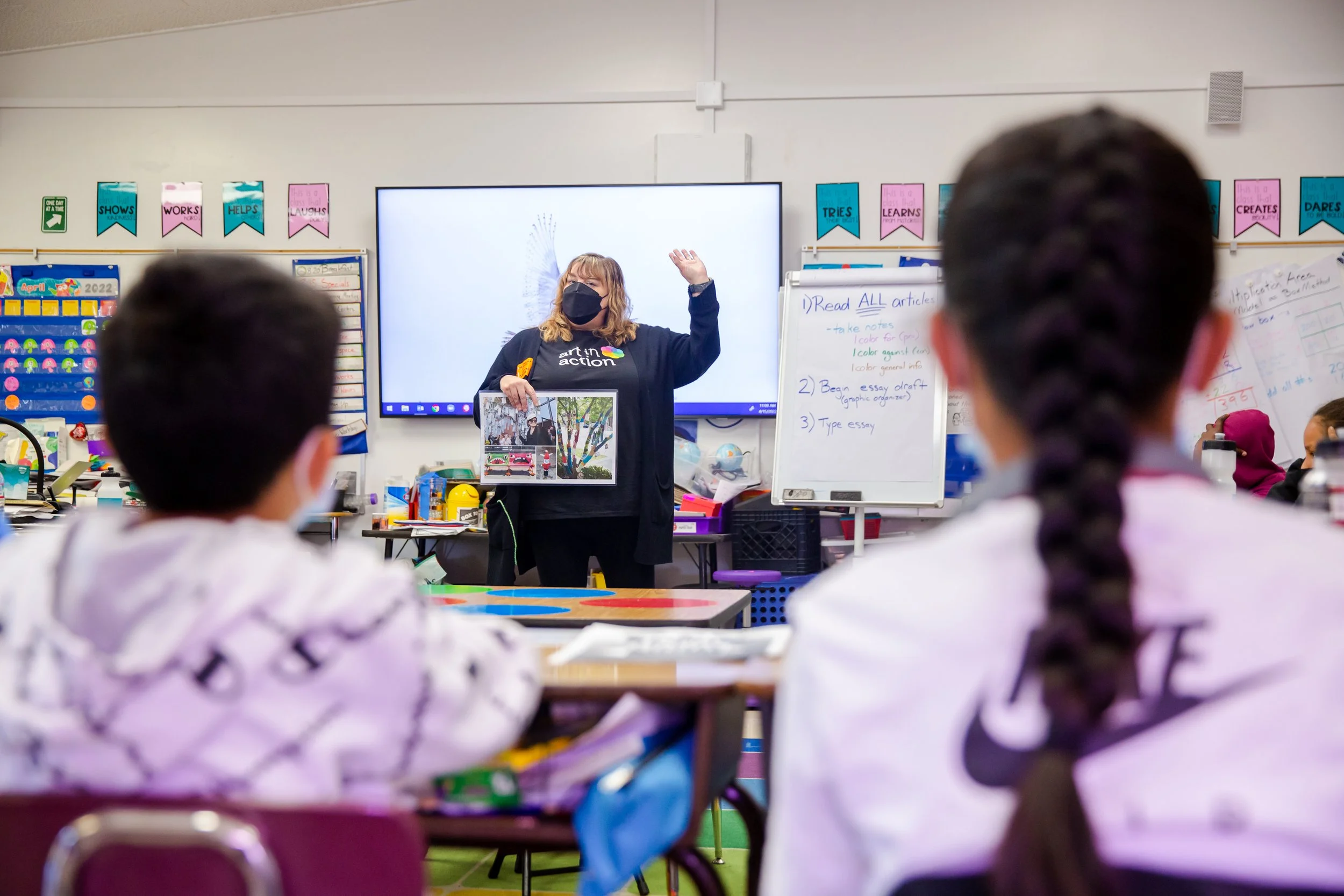 teacher with hand up in the classroom
