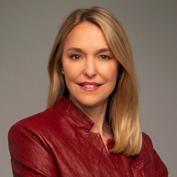 Wendy Bergh headshot, she is smiling with a red jacket on