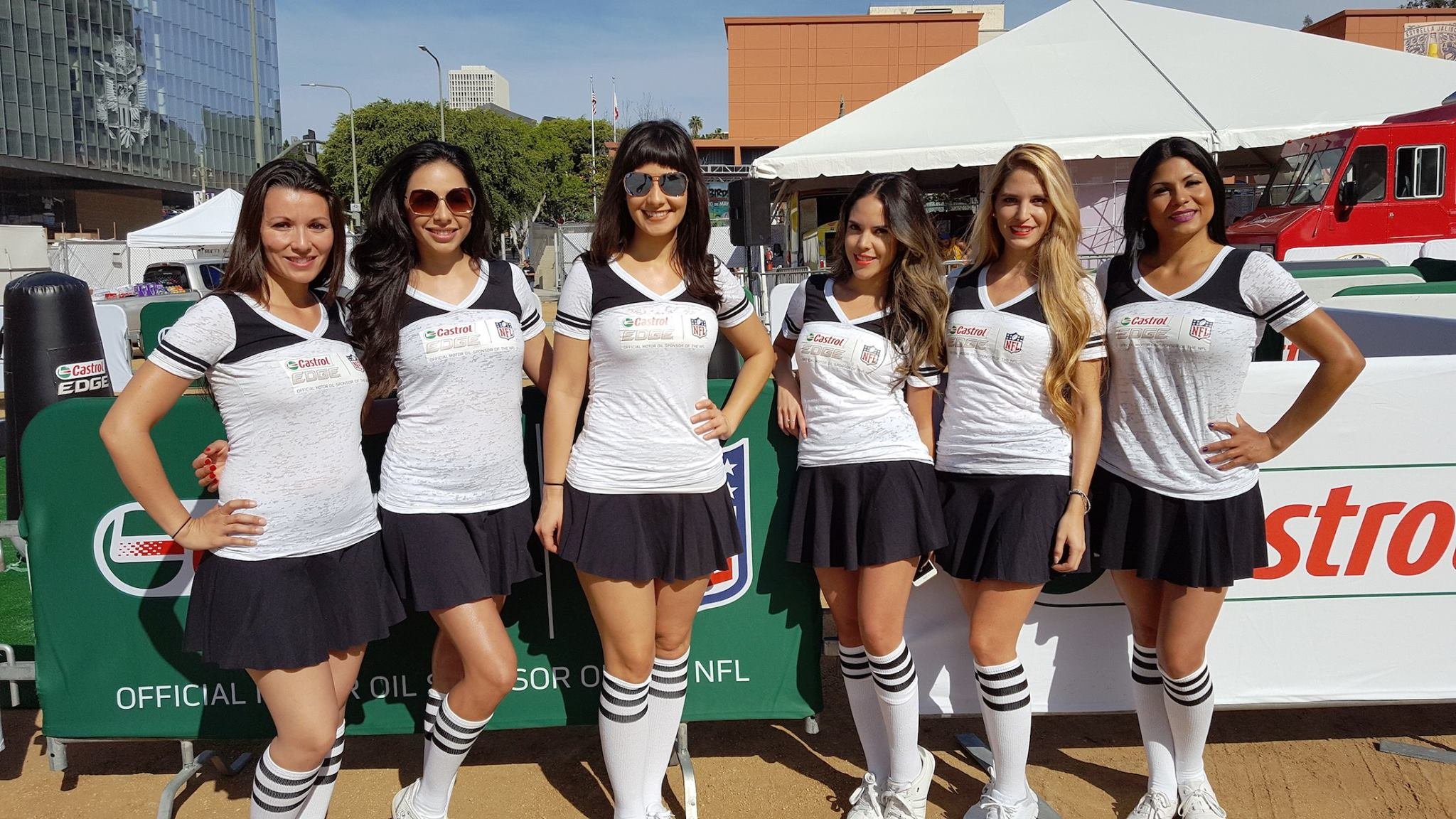 Castrol Edge brand ambassadors and event staff in matching uniforms posing outdoors in front of a promotional banner - Event Staffing Live