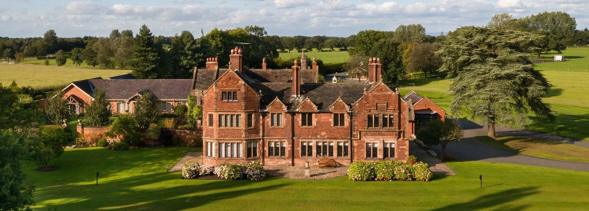 Cheshire Wedding Videographer, drone shot of Colshaw Hall on a sunny day