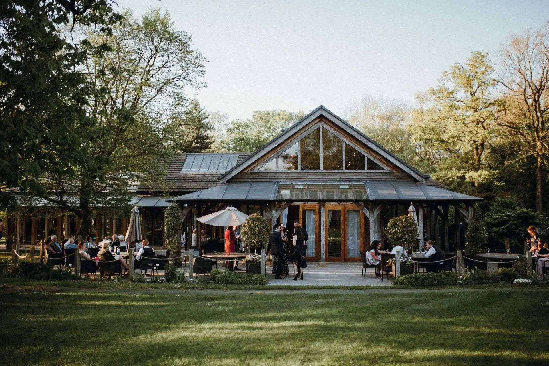 Cheshire wedding venue, outside photo of Oaktree of peover during drinks reception on a sunny day