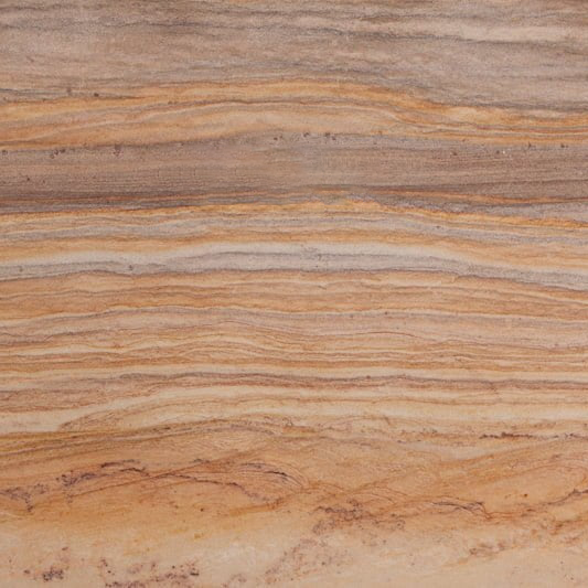 Close-up of layered sandstone rock with various shades of brown and beige.