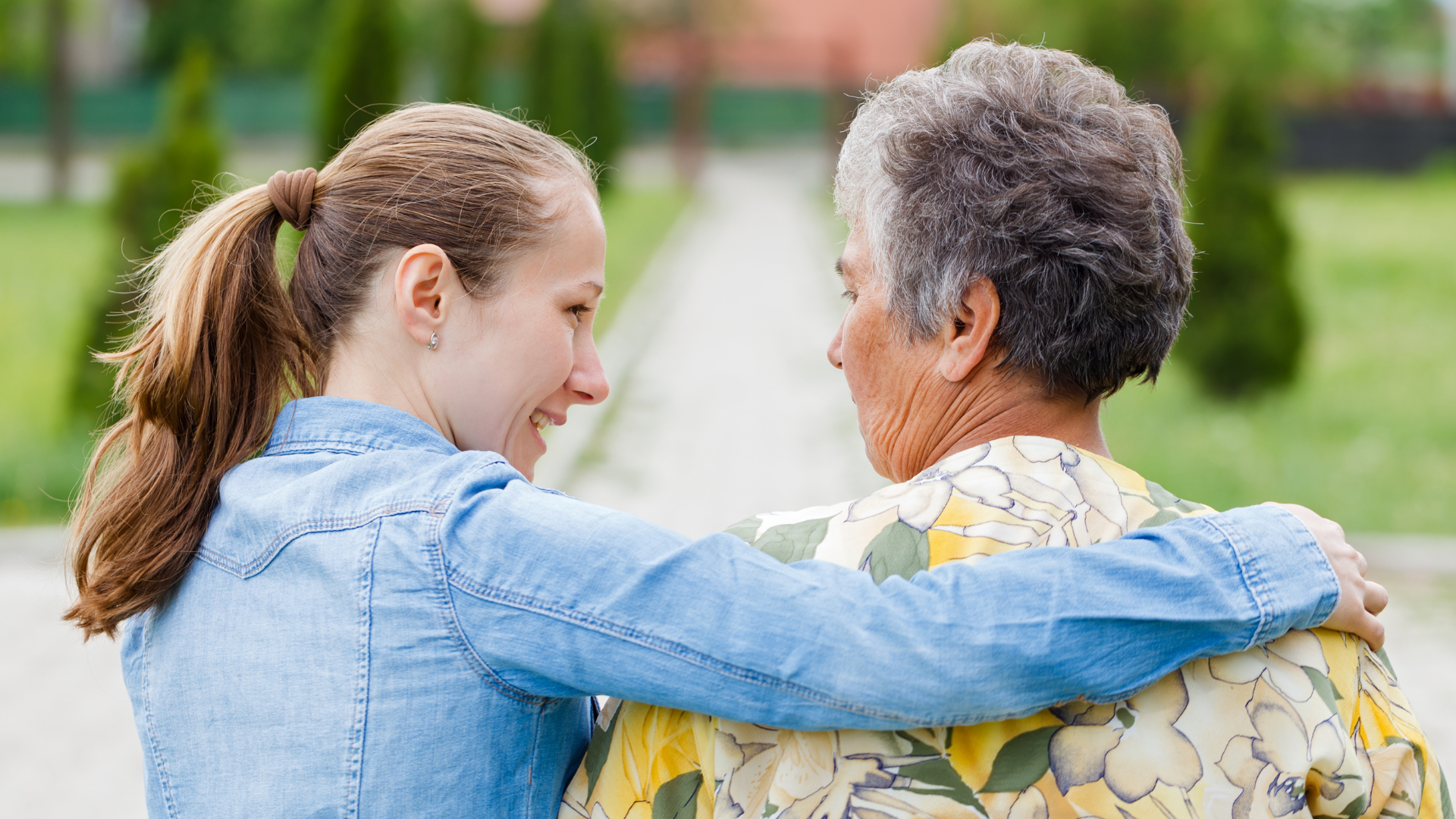 An aide assisting woman walking