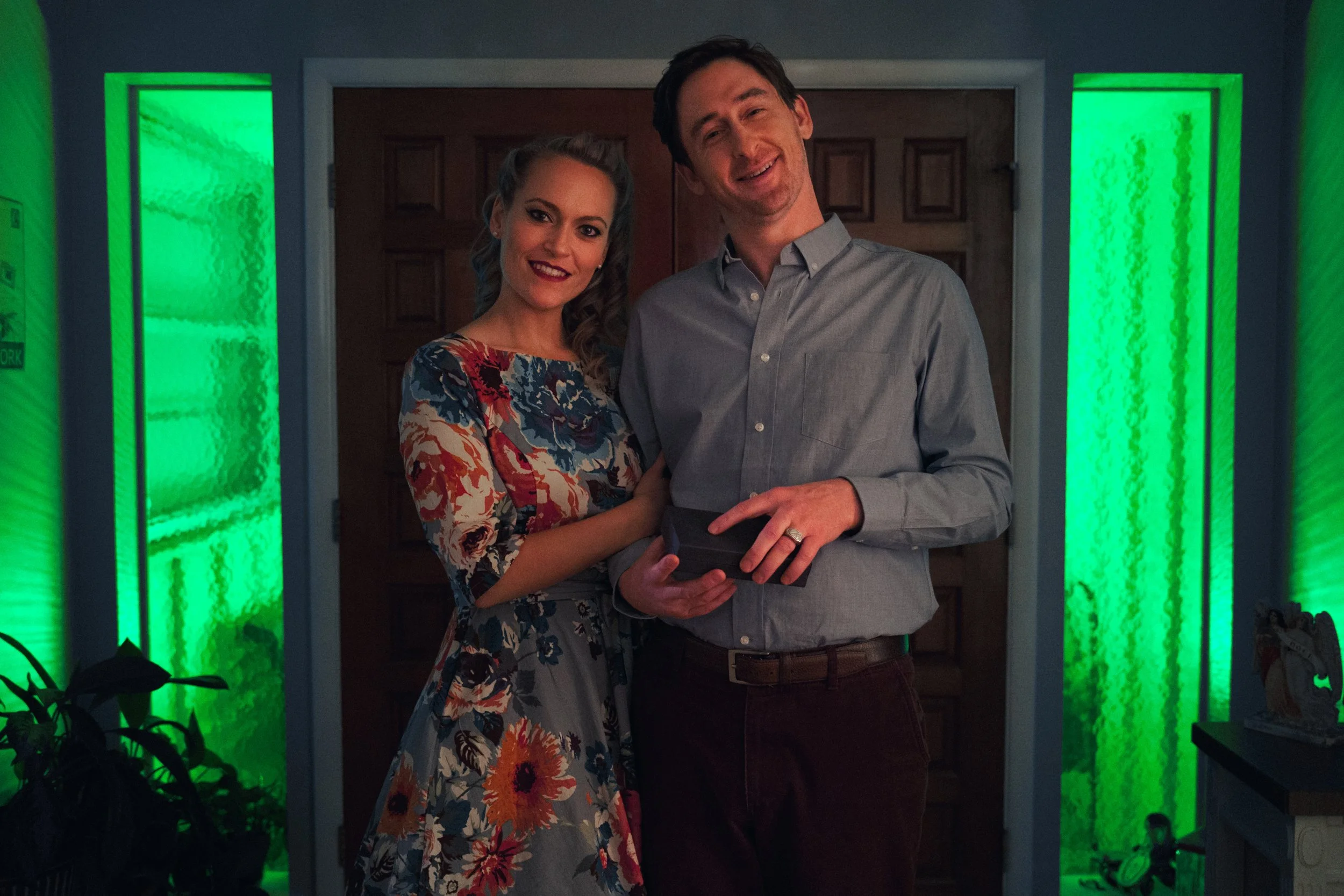 A young couple standing in a doorway.