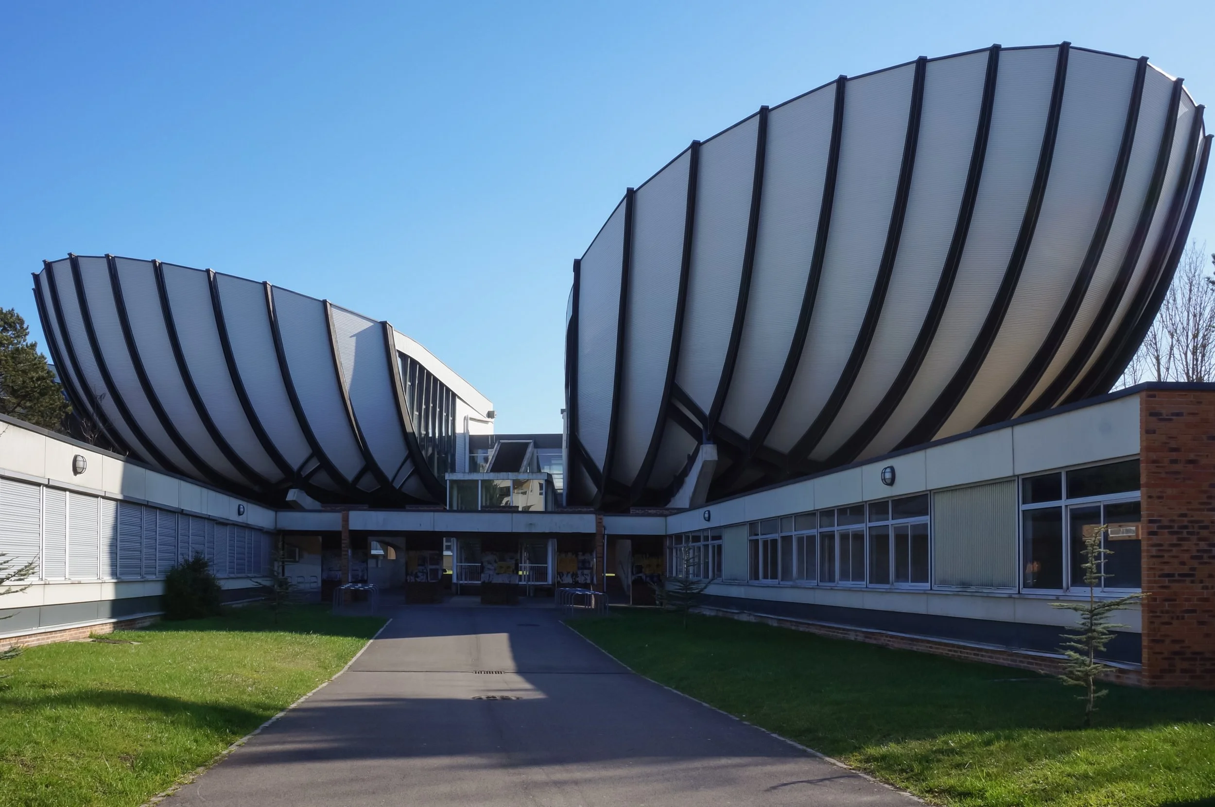 Reims, France - June 2022 - Seashell-shaped amphitheaters of the main building of Croix-Rouge Campus, at the entrance of the Faculties of Humanities and Law of Reims Champagne-