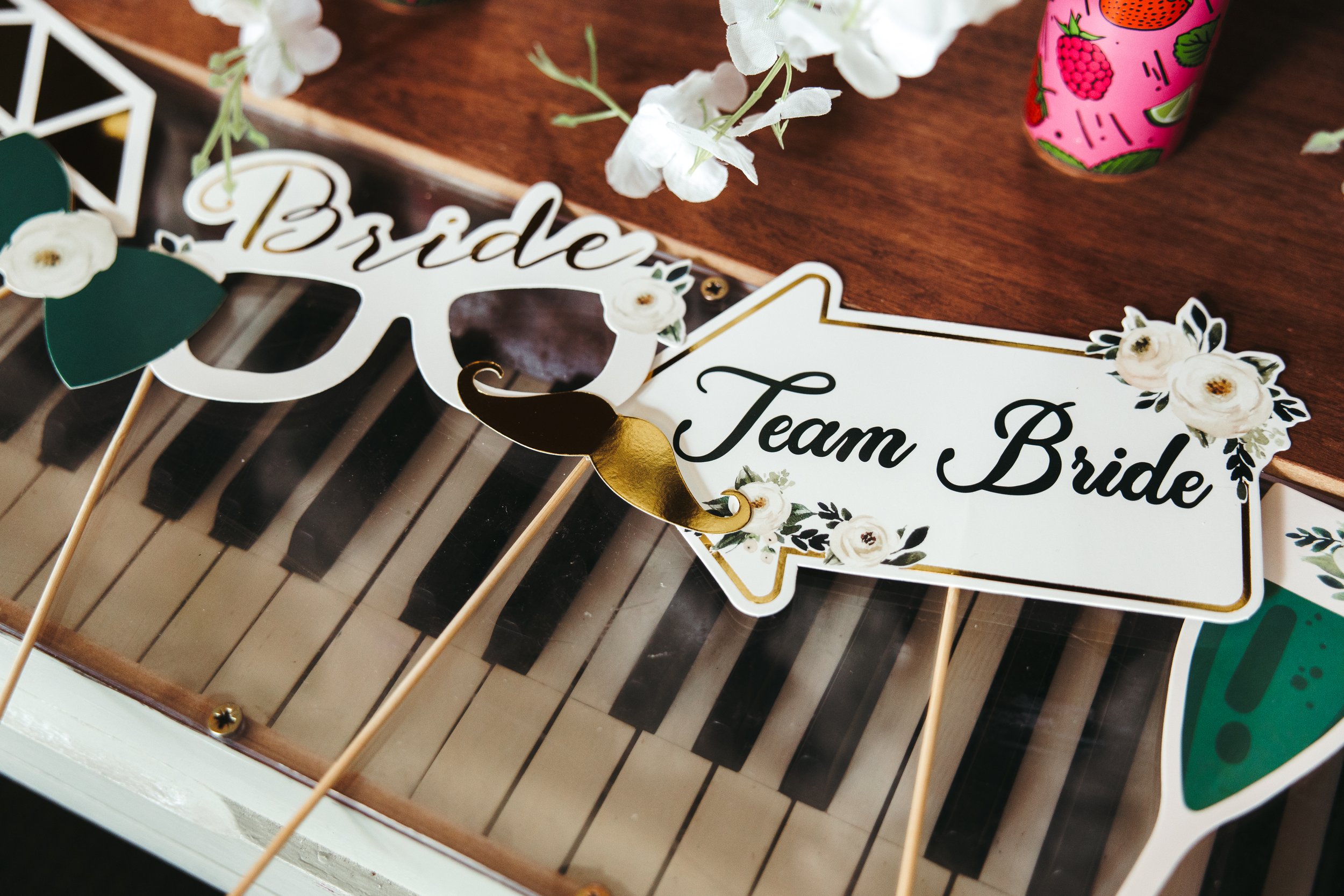 A young boy with short brown hair and blue eyes, smiling, wearing a white dress shirt and a navy blue bow tie with white polka dots, sitting with his arms crossed.