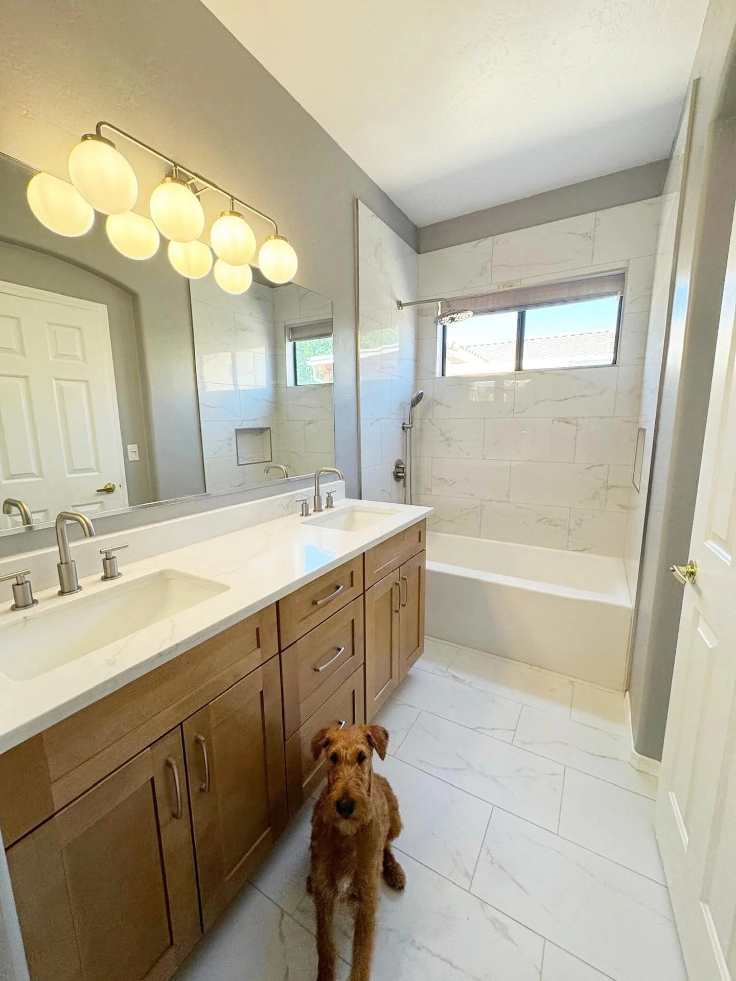 This bathroom remodel deserved its own post with our happy customer Eileen 🐶🤭 we replaced the vanity cabinets, countertop, faucets, vanity lights, new tub surround, new bath floor. #remodel #remodeledhome #tucsonaz #smallbuisness #bathroom #bathroo