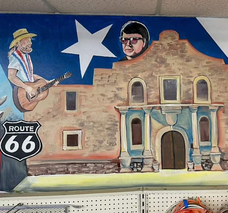 Willie Nelson above Route 66 sign on left side, Alamo in Center with Texas flag star above