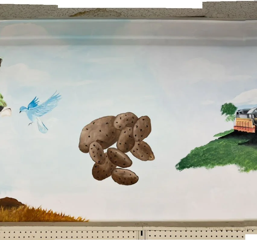 blue bird on left side of image, potatoes in center, train car on right